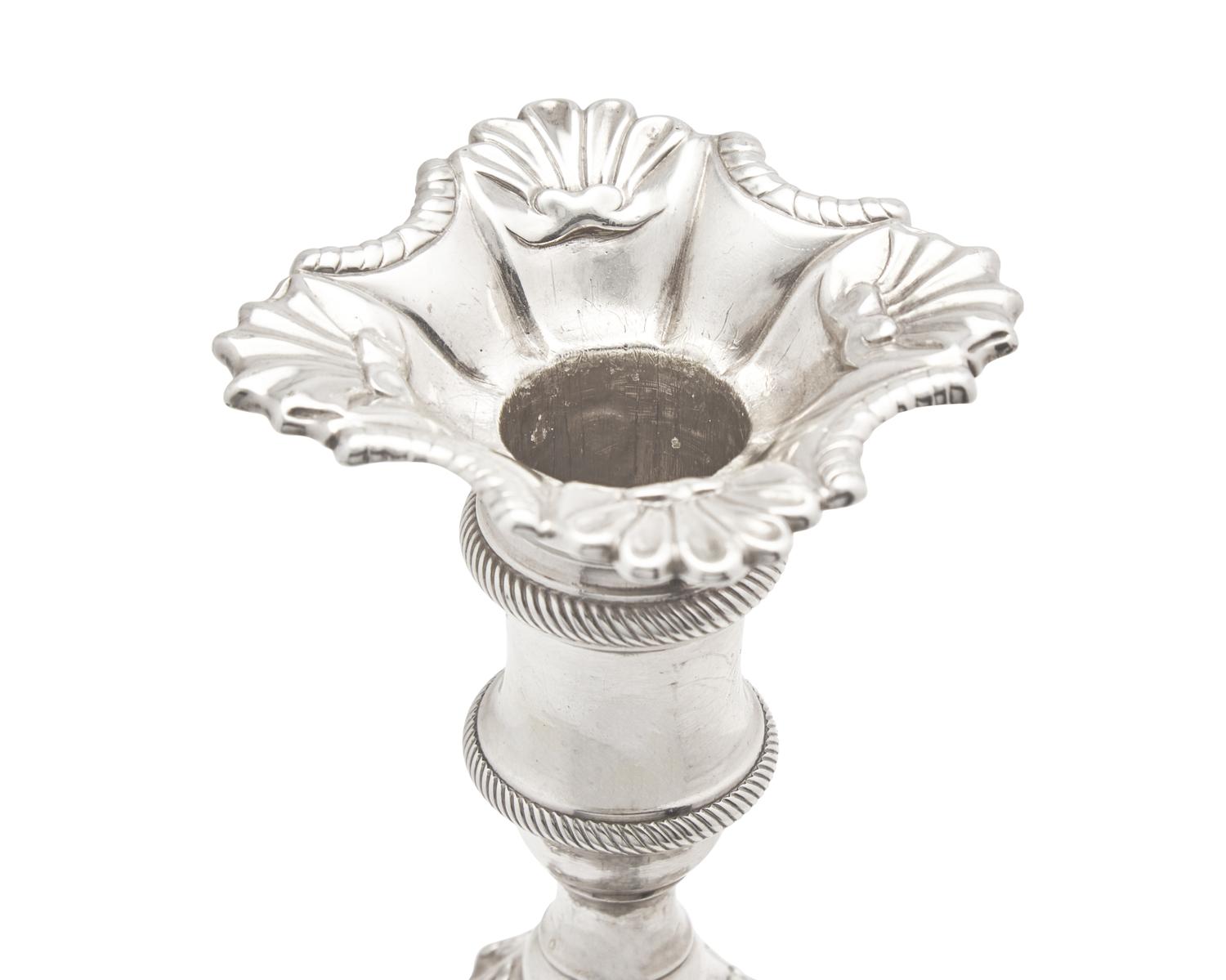 An Assembled Set Of Four George III Sterling Silver Candlesticks