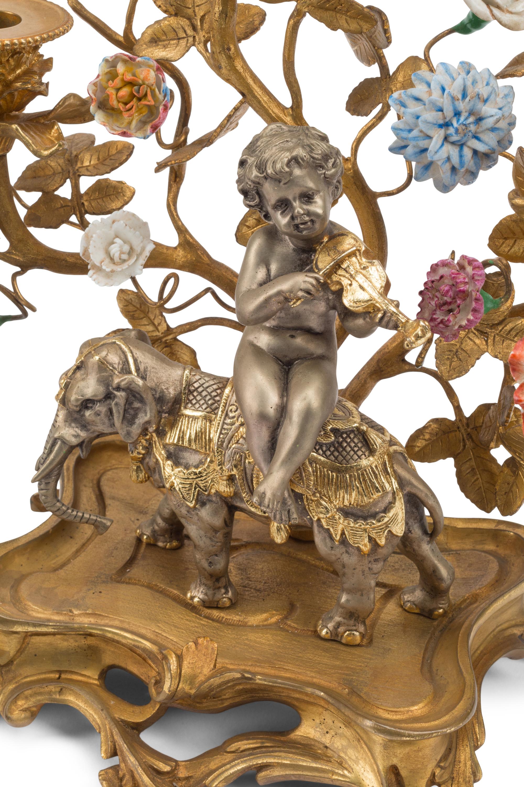 A Pair of Louis XV Style Gilt Bronze, Silvered Bronze and Porcelain Candelabra