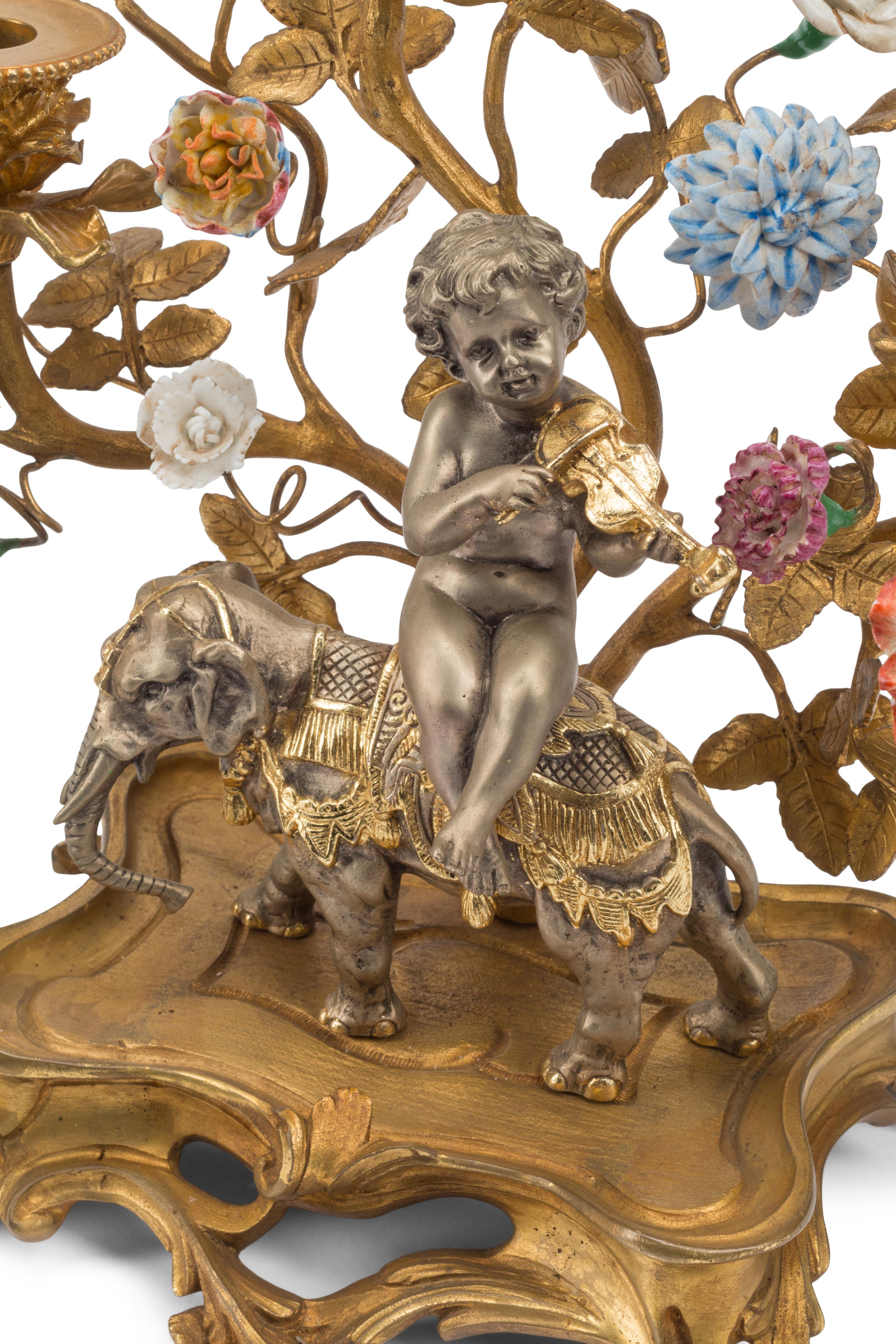 A Pair of Louis XV Style Gilt Bronze, Silvered Bronze and Porcelain Candelabra
