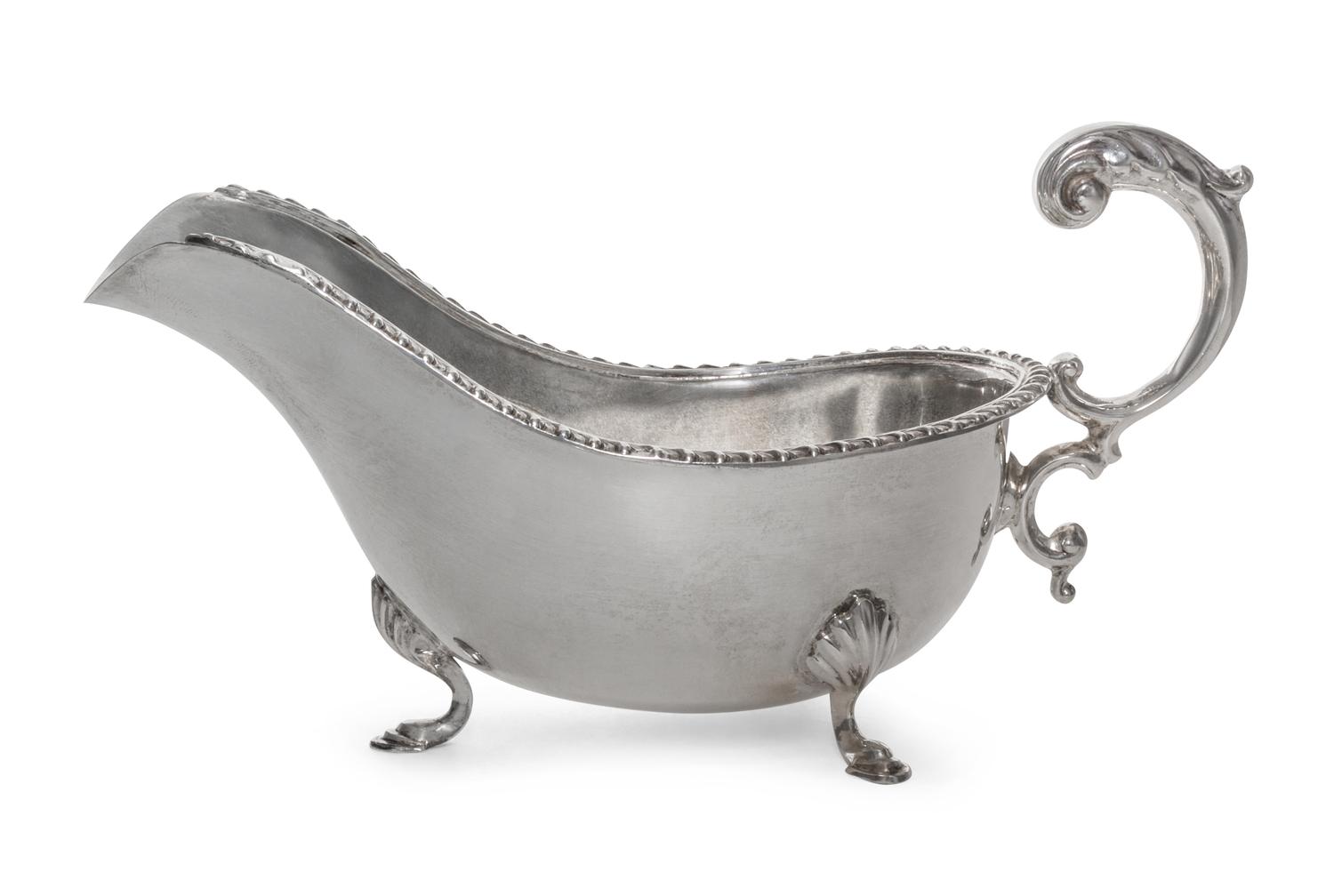 A Canadian Silver Sauce Boat, Henry Birks & Sons, Montreal, 20th Century, of typical form with a gadrooned border and leaf-capped flyin