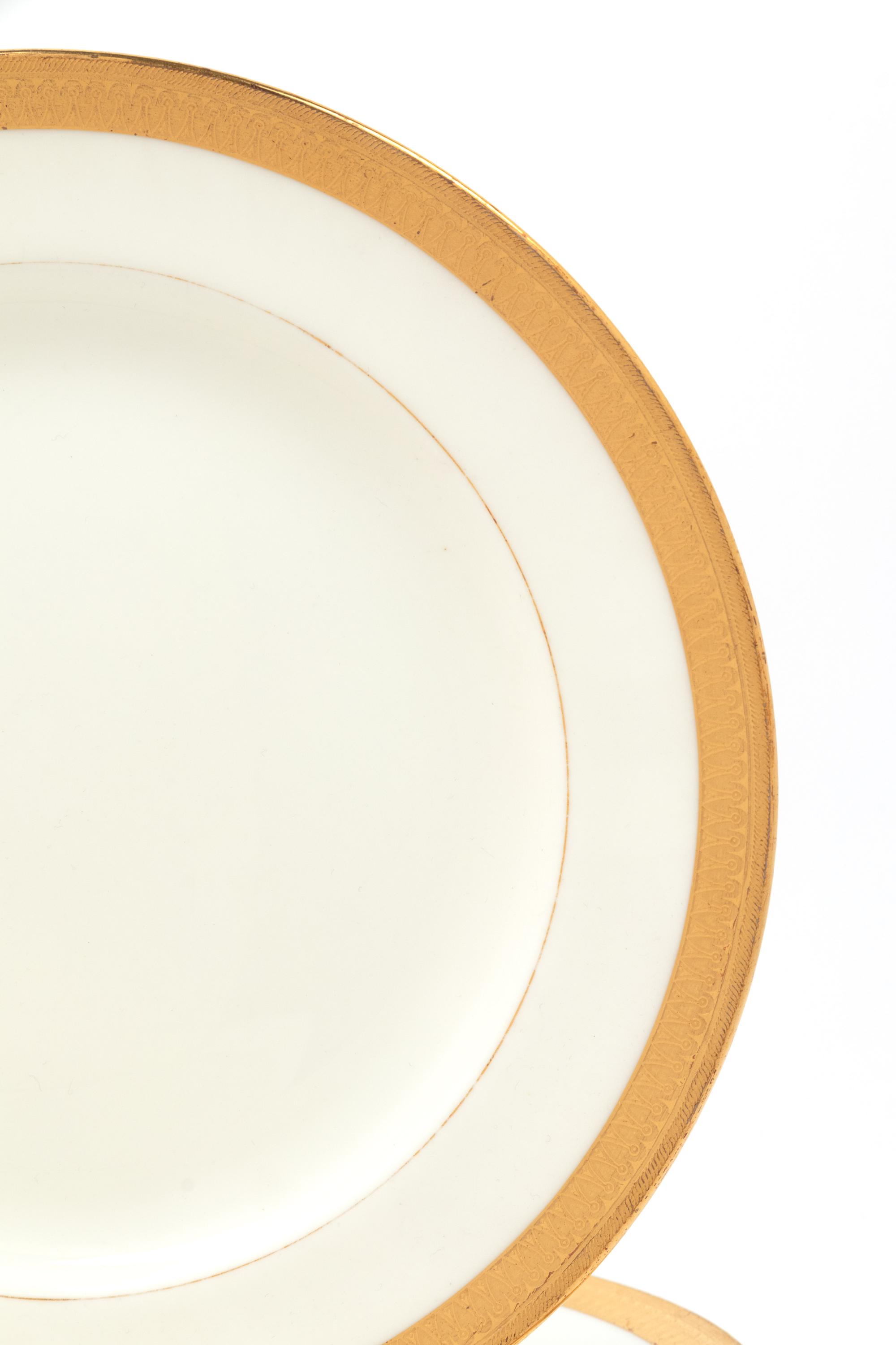 A Mintons Parcel Gilt Porcelain Dinner Service