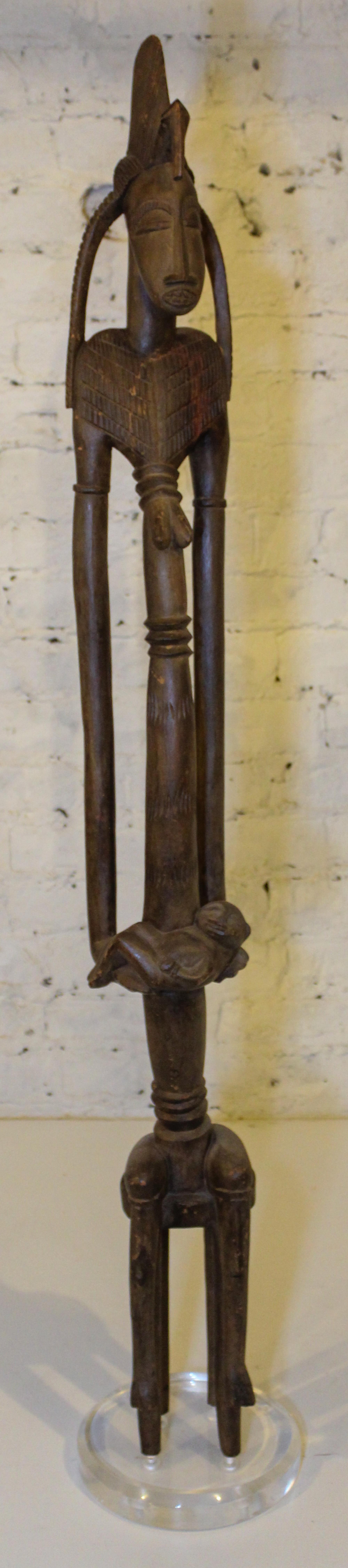An African Carved Wood Maternity Figure Height 48 inches (overall).