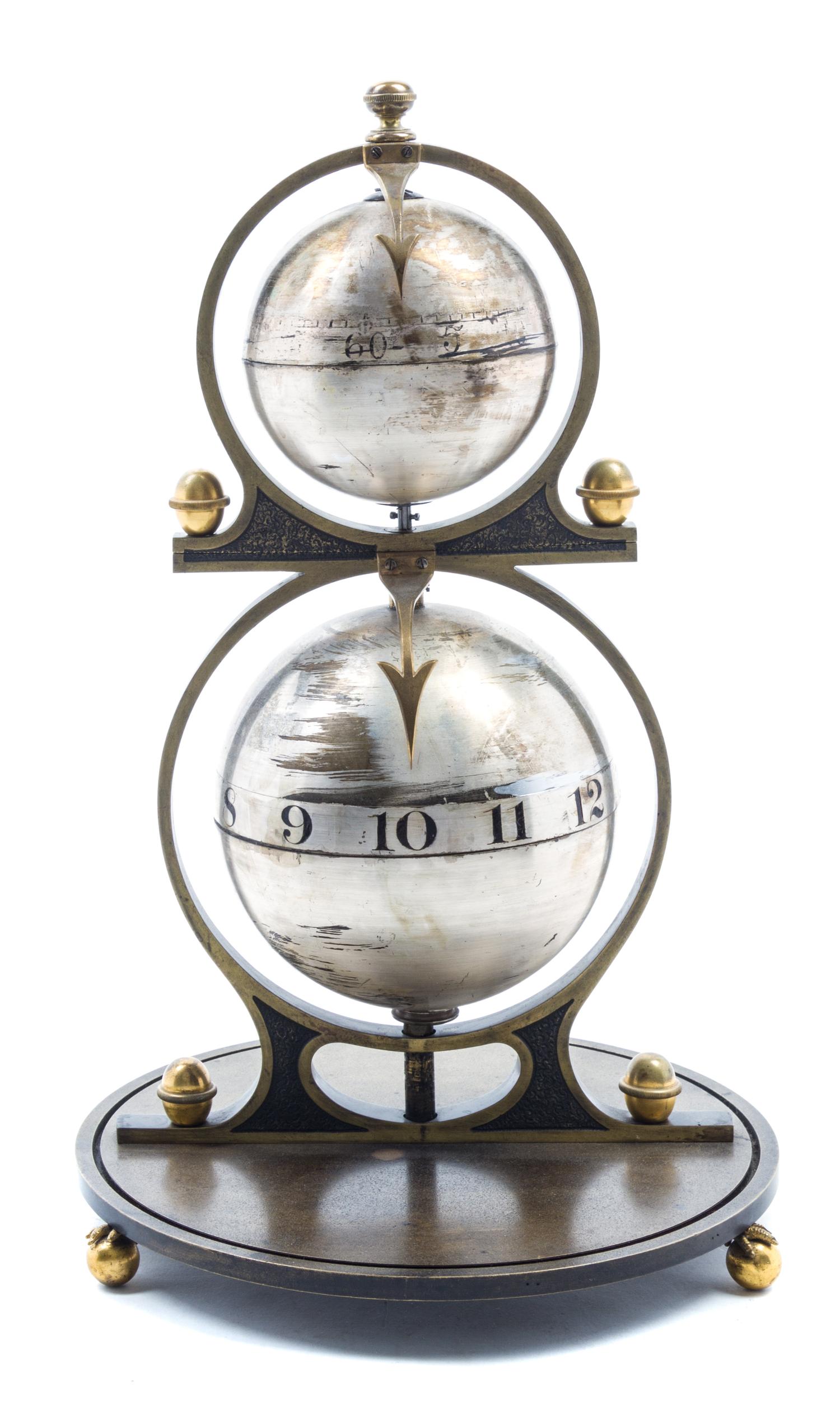 A Gustave Jeager Double Globe Patent Clock Height overall 16 inches. — LATE 19TH/EARLY 20TH CENTURY