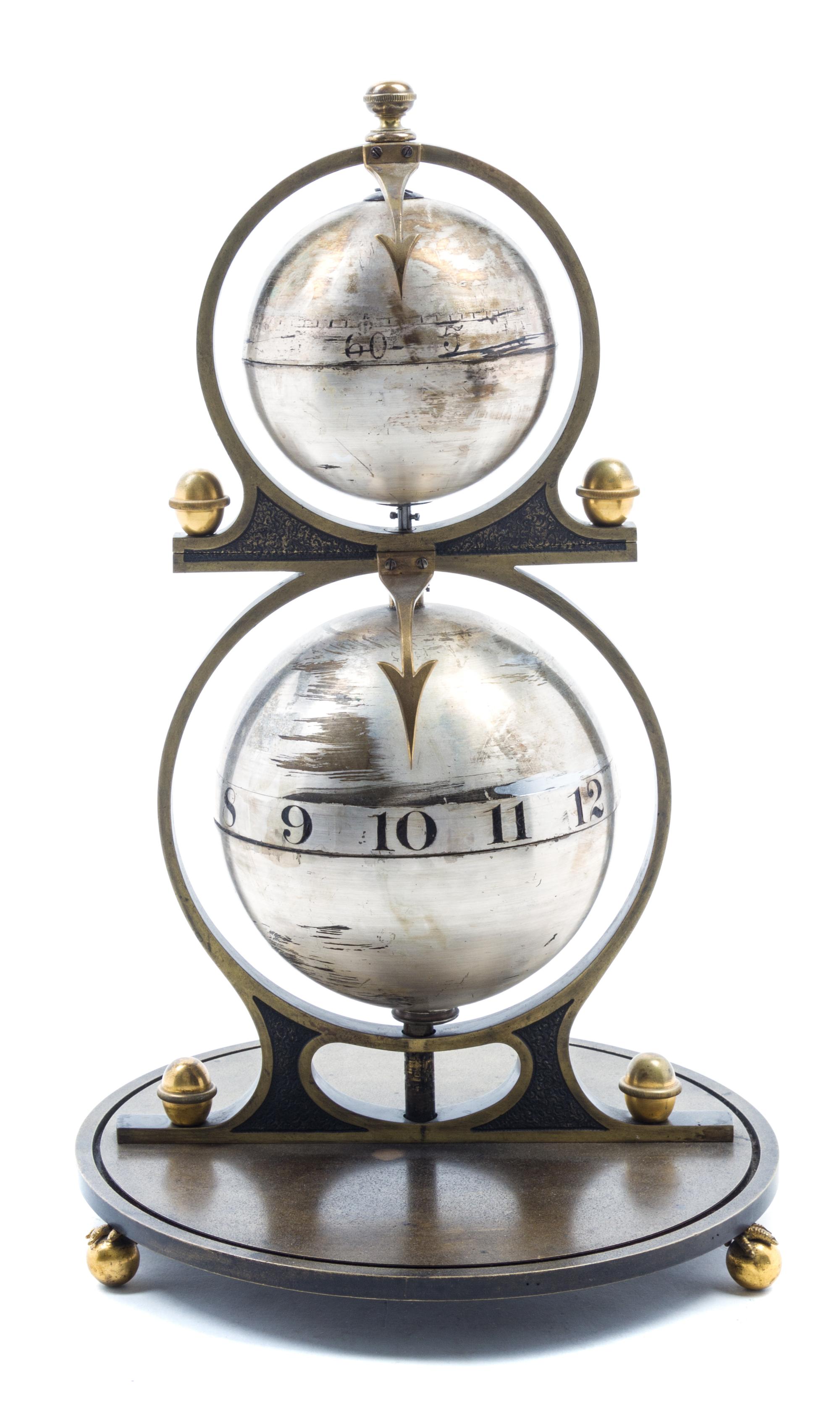 A Gustave Jeager Double Globe Patent Clock Height overall 16 inches. — LATE 19TH/EARLY 20TH CENTURY