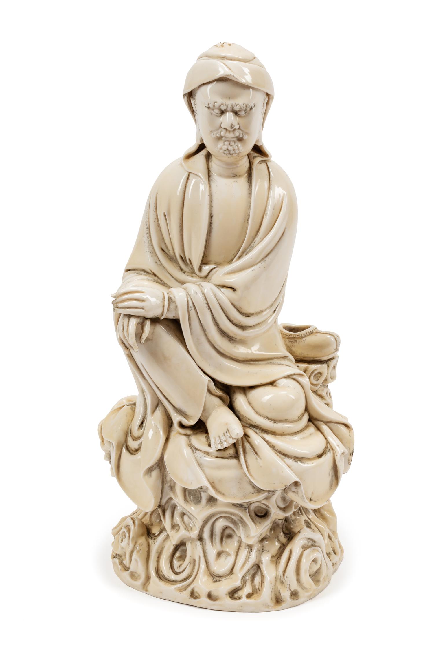 A Chinese Export White Glazed Porcelain Figure of a Seated Luohan