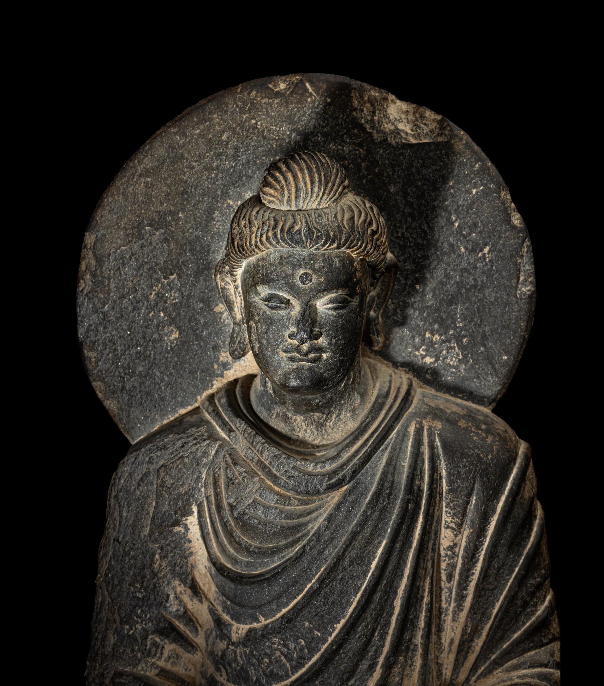 A Gandharan Grey Schist Figure of Seated Buddha