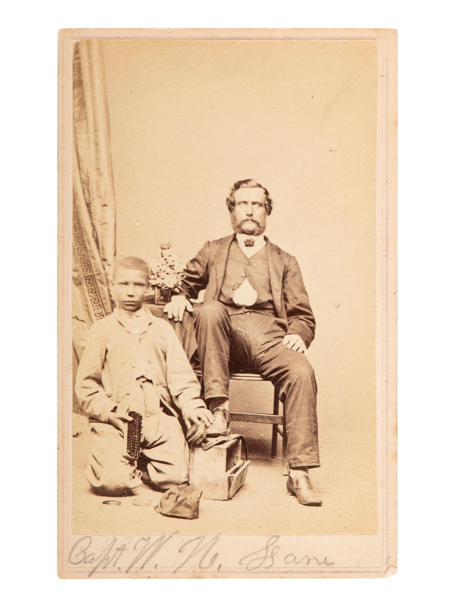 [EARLY PHOTOGRAPHY]. CDV of Capt. W.H. Lane & an African American shoeshiner. Norfolk, VA: Holmes.