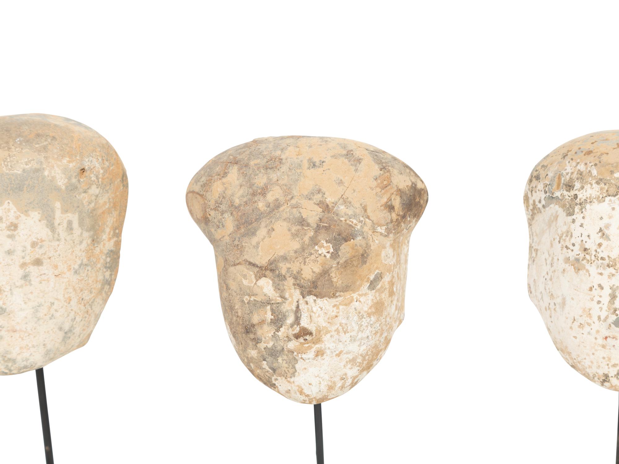 Four Tang Pottery Heads on Stands