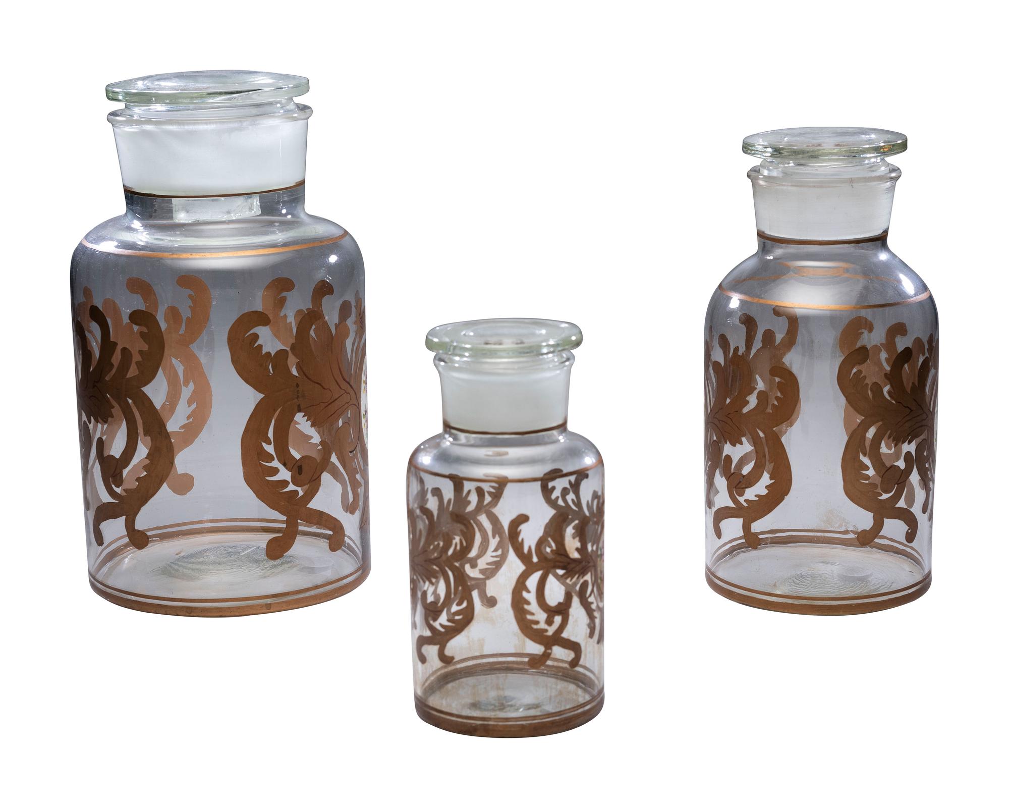 Three Graduated Paint and Gilt Decorated Glass Storage Jars