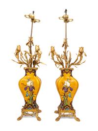 A Pair of Continental Gilt Metal Mounted Polychrome Glazed Porcelain Lamps