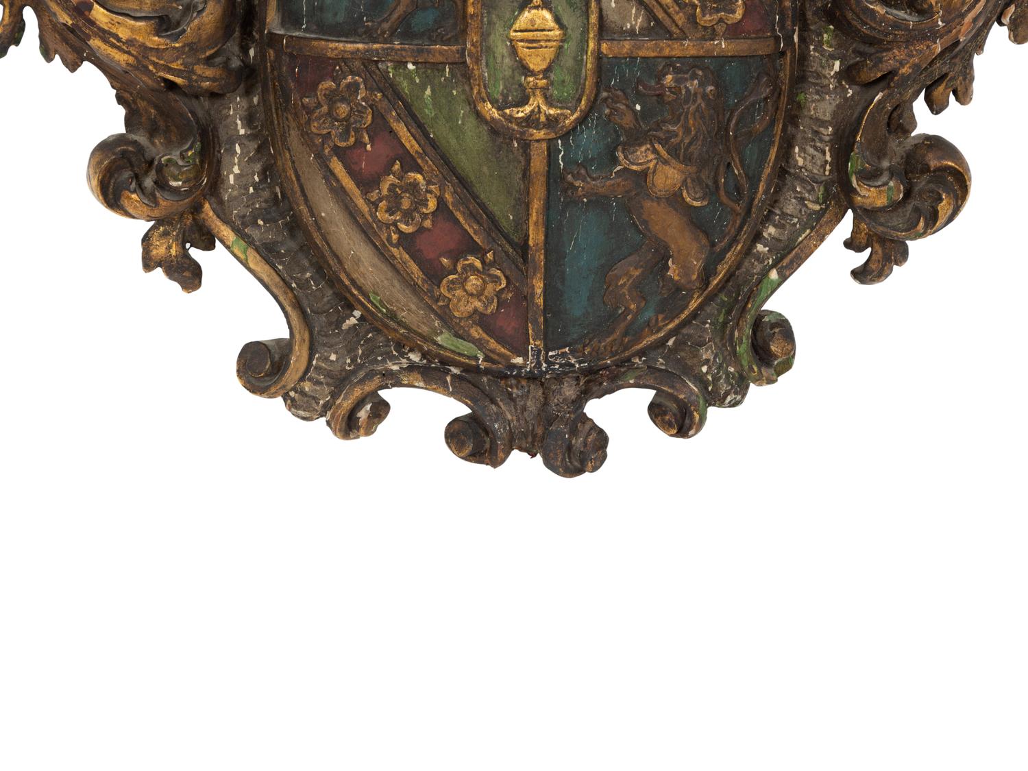 An Italian Painted and Parcel Gilt Carved Armorial Plaque