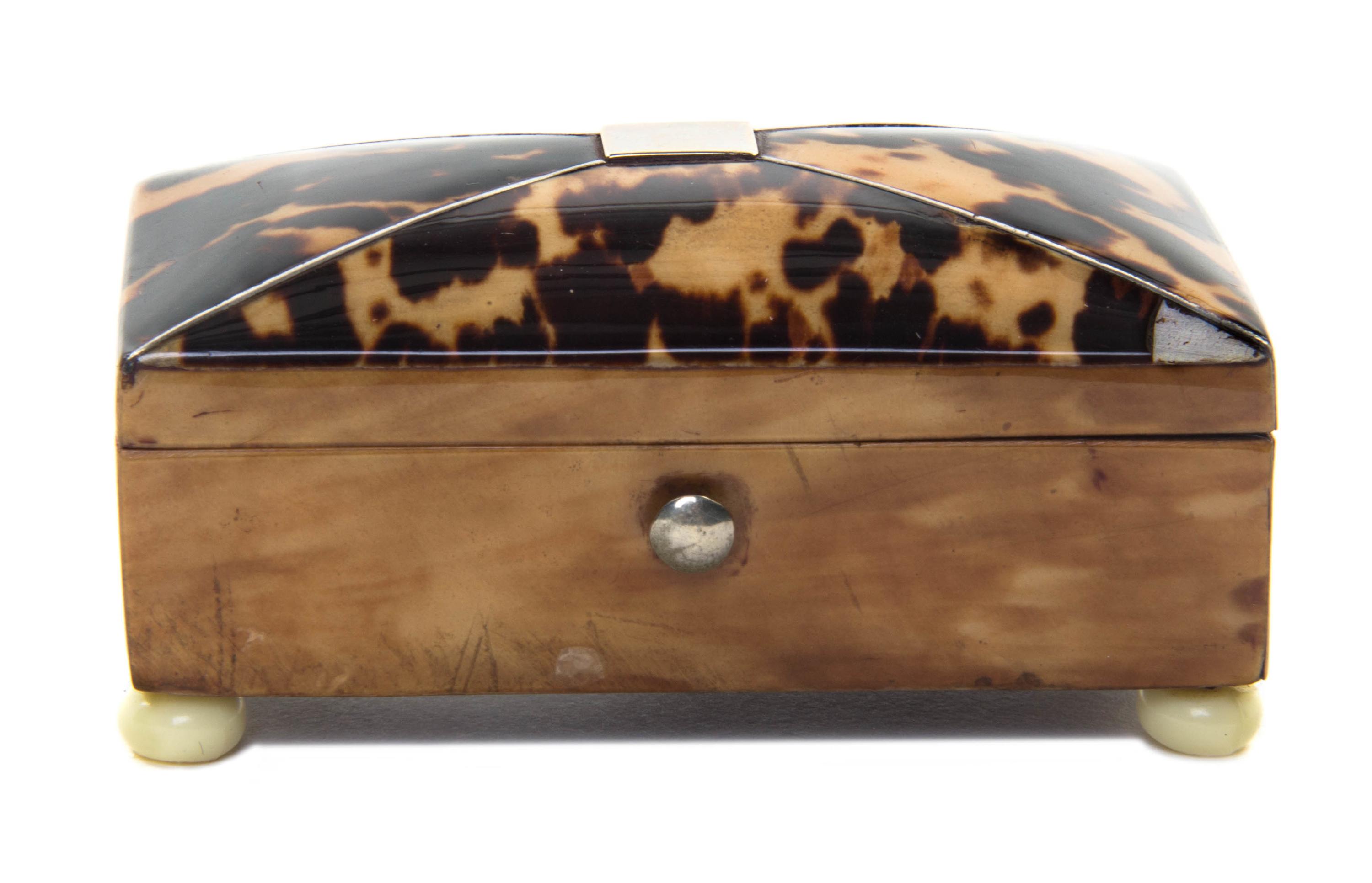 An English Tortoise Shell Tea Caddy, Height 1 1/4 x width 2 3/4 x depth 1 1/2 inches.