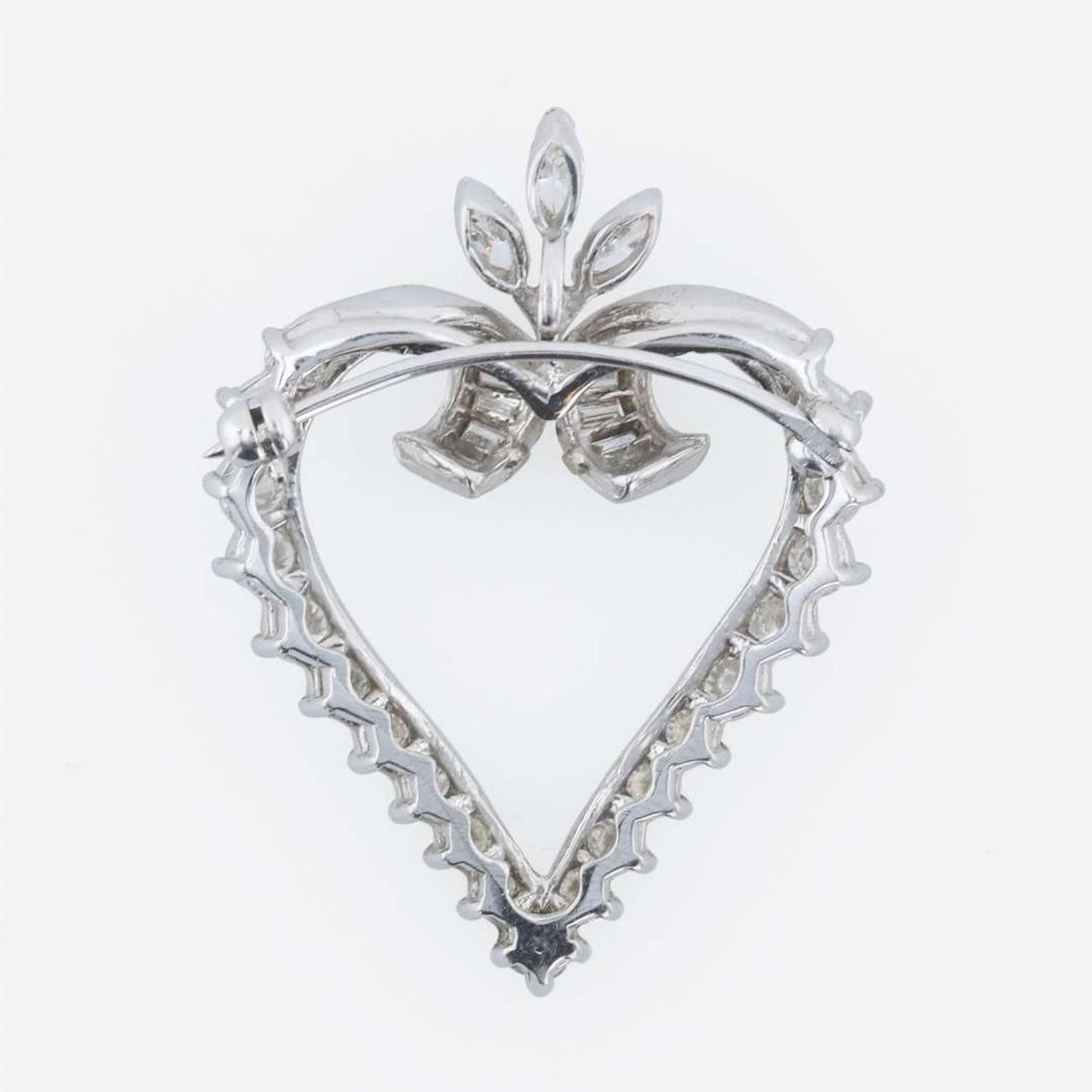 A platinum and diamond pendant/brooch