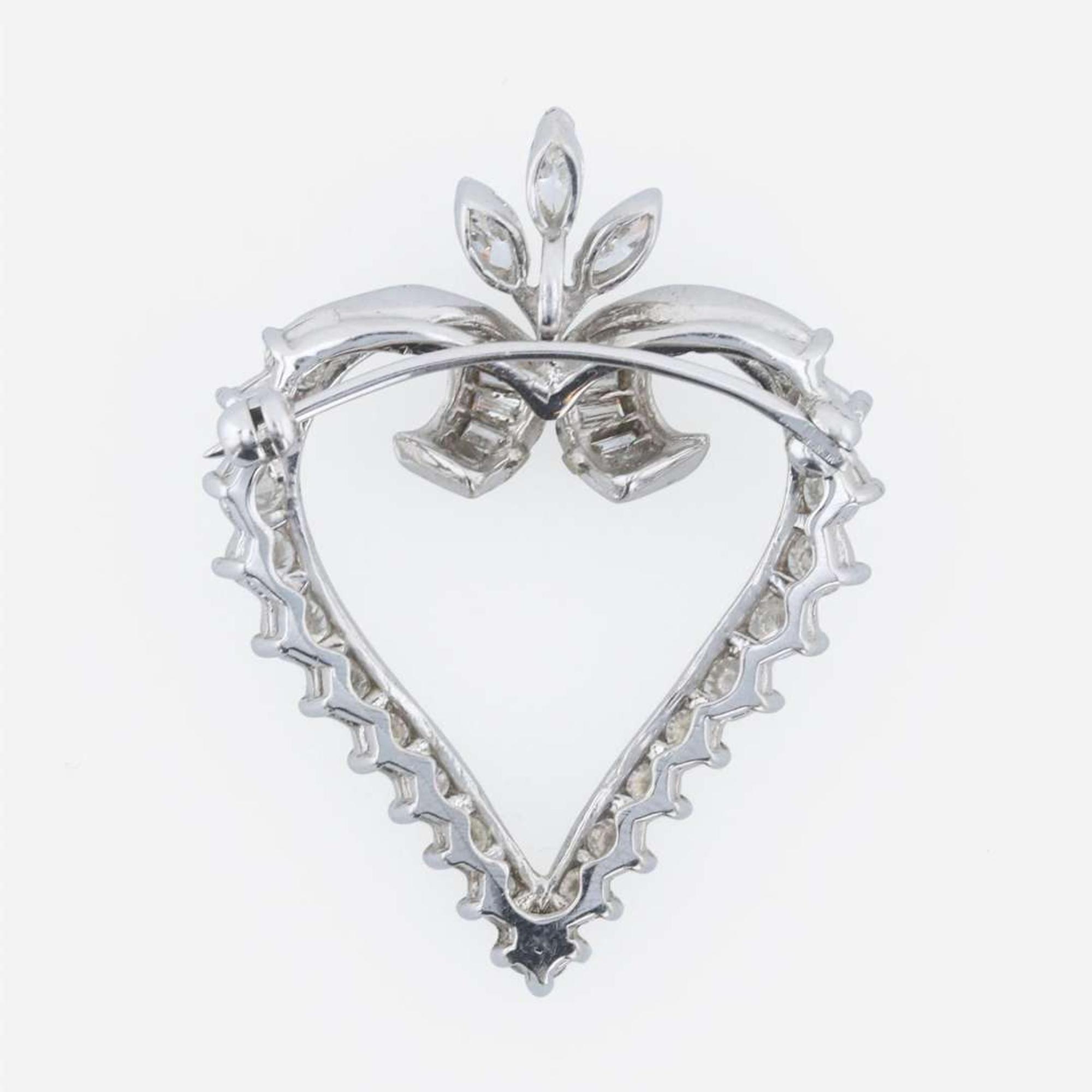 A platinum and diamond pendant/brooch