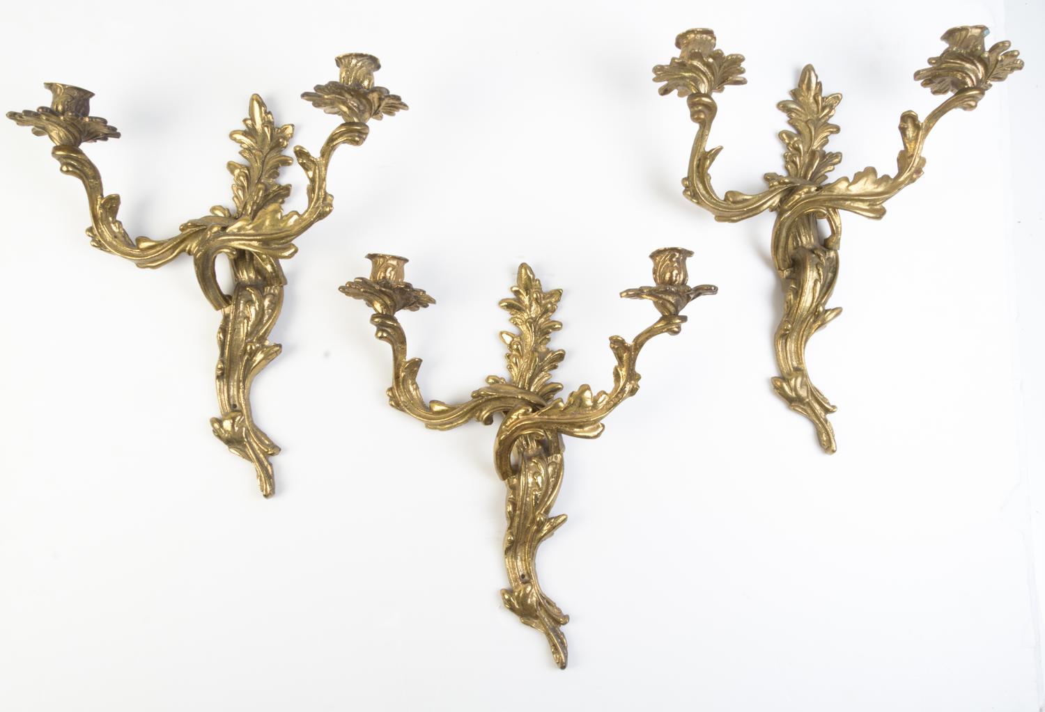 A Set of Three Louis XV Style Brass Two-Light Sconces Height 16 inches.