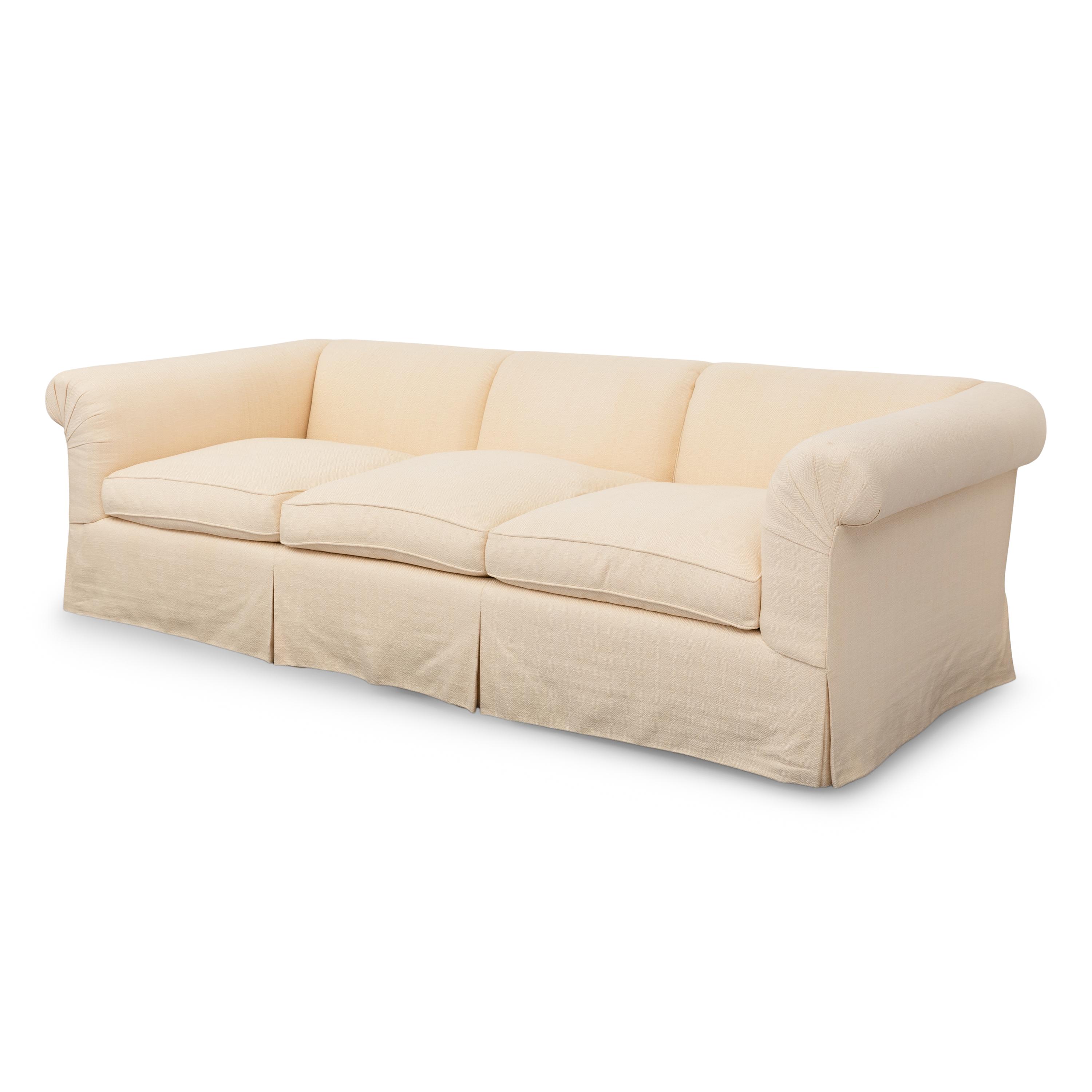 A Cream-Twill Upholstered Three-Cushion Sofa
