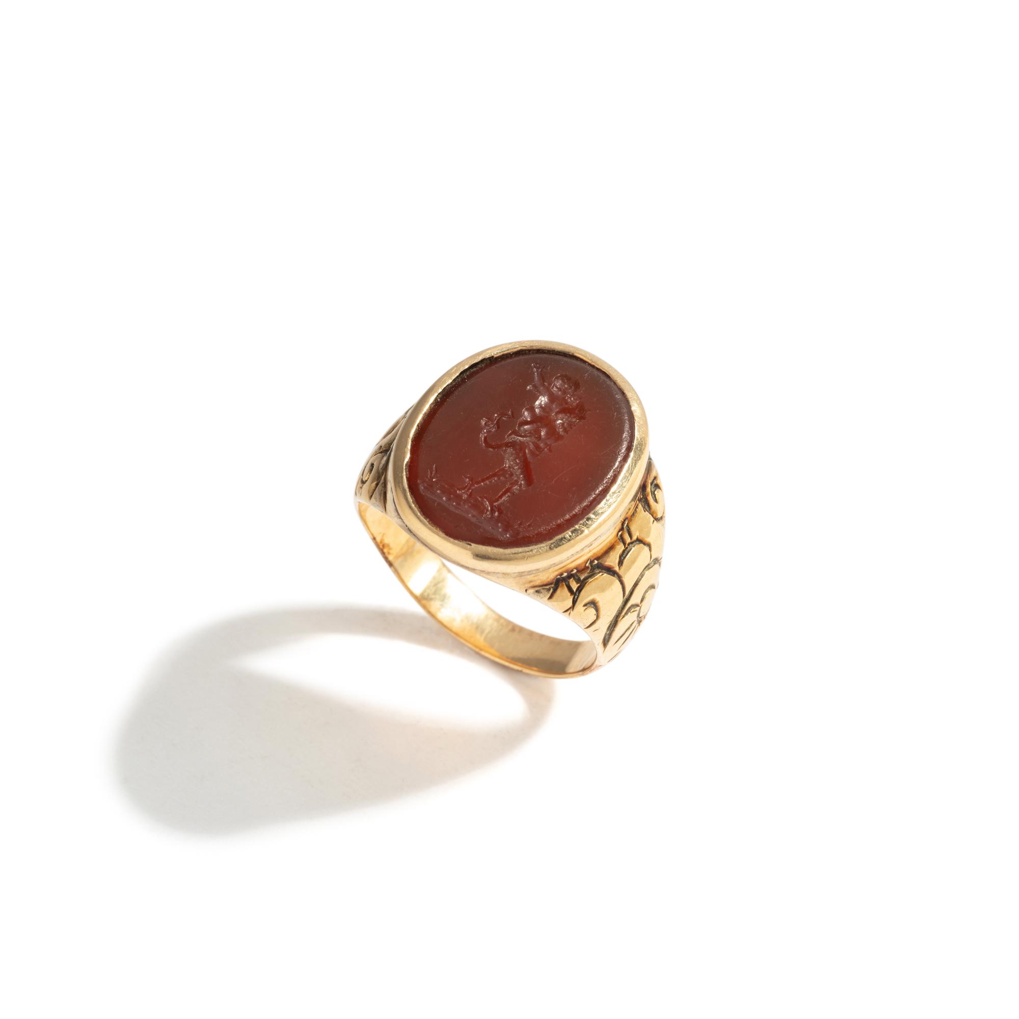 A Neoclassical Gold and Carnelian Finger Ring with the God Eros Riding a Satyr
