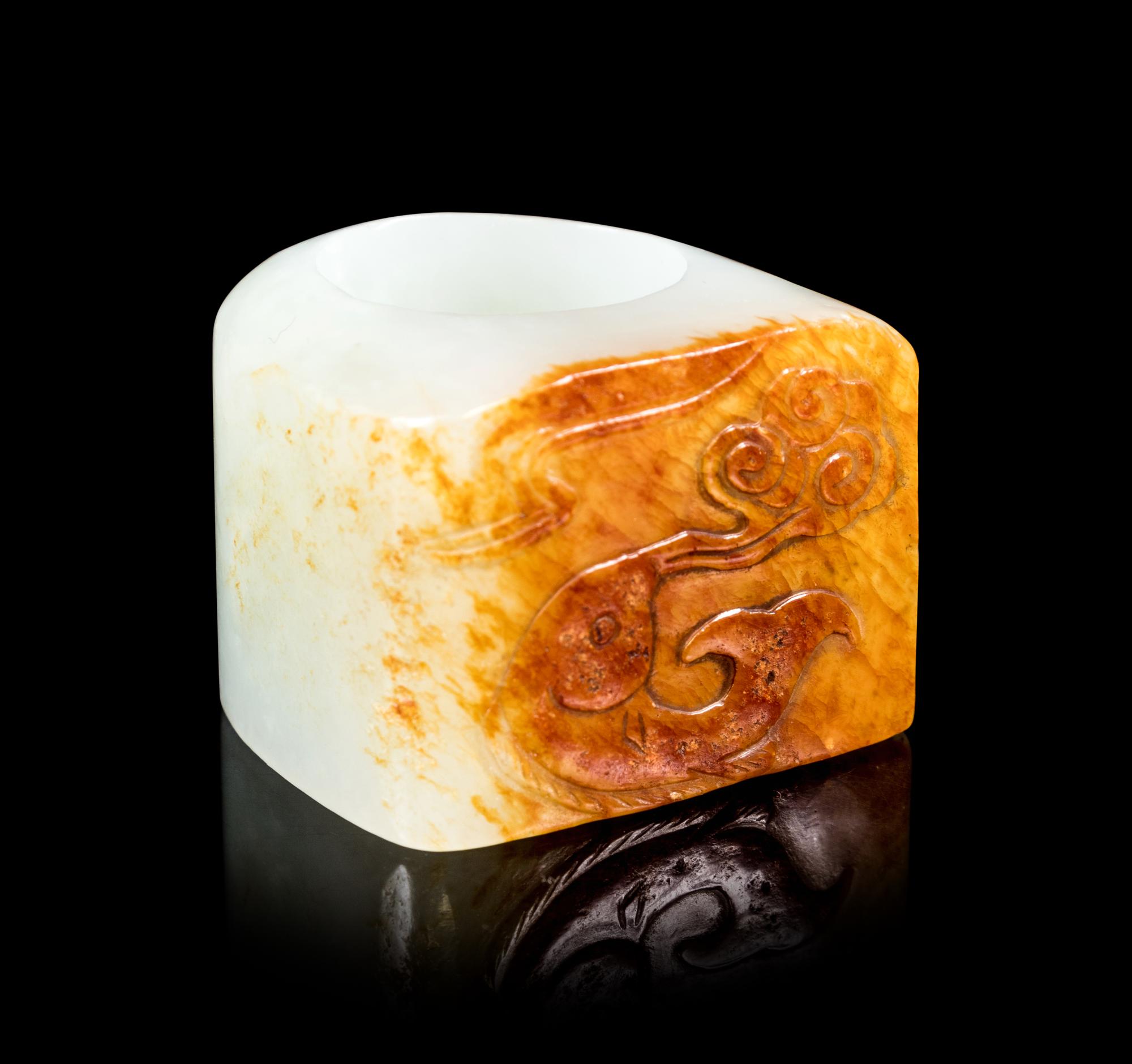 A Chinese White and Russet Jade Archer's Ring