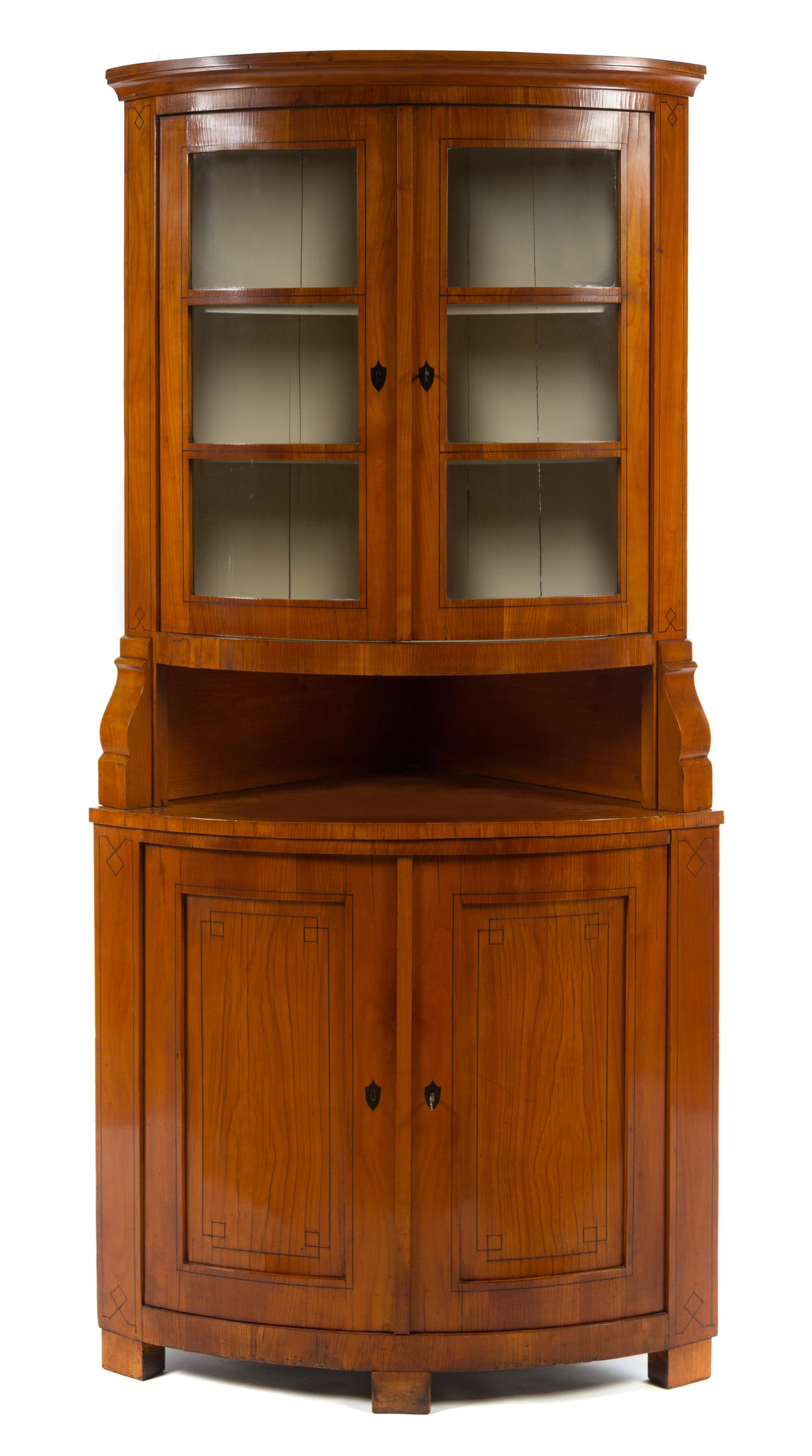 A Biedermeier Fruitwood Corner Cabinet Height 81 x depth 25 inches.