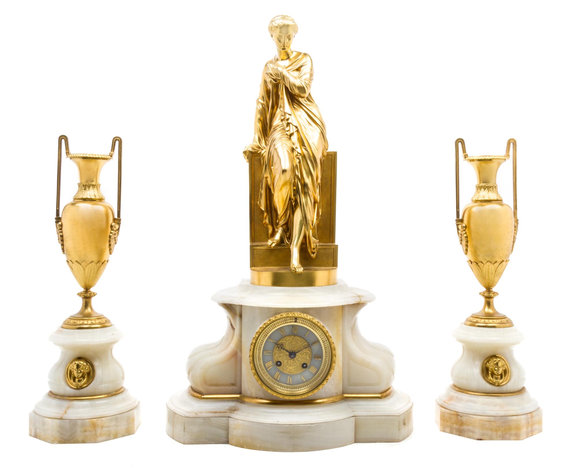 A French Gilt Bronze Mounted Onyx Clock Garniture Height of clock 25 inches.