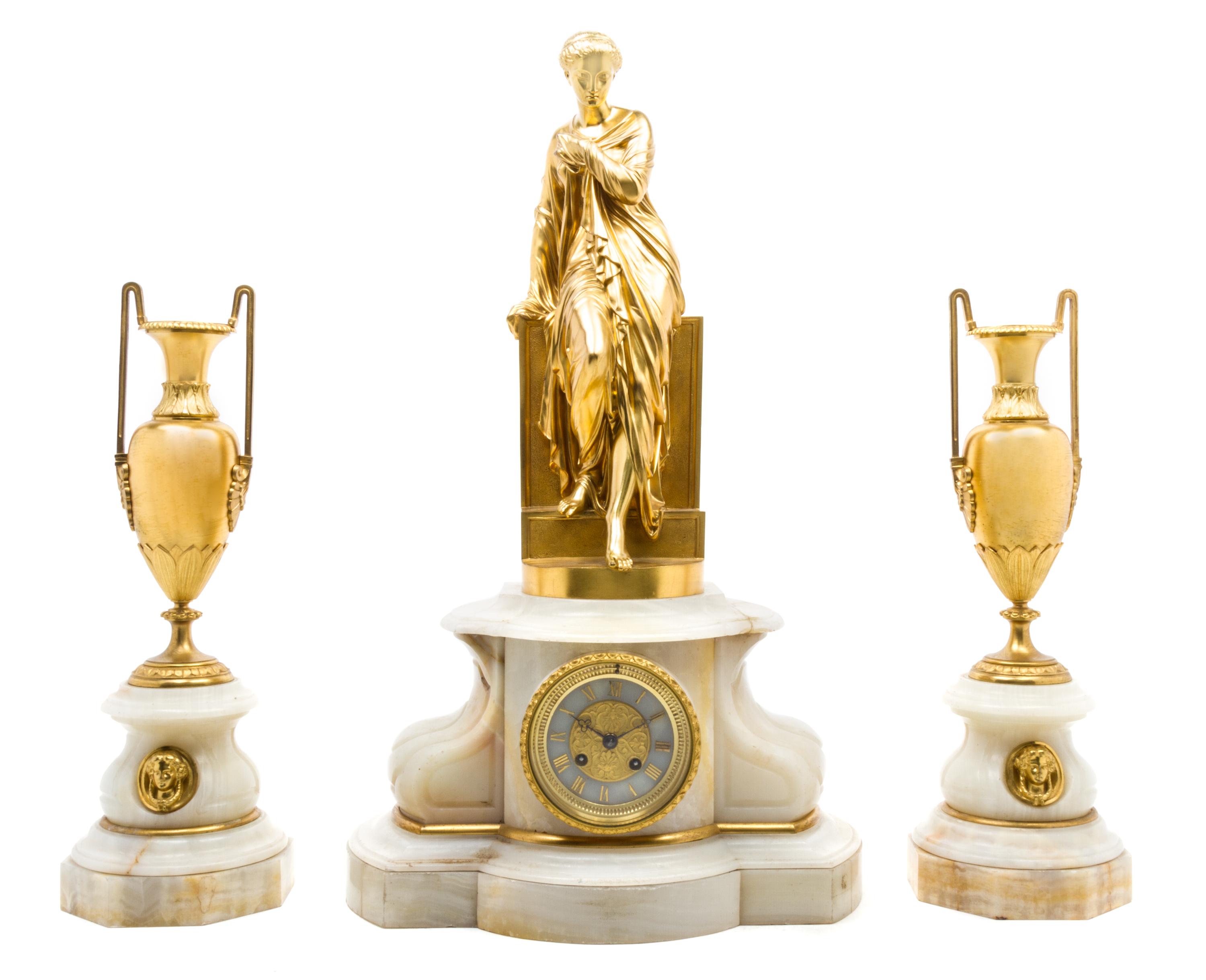 A French Gilt Bronze Mounted Onyx Clock Garniture Height of clock 25 inches.