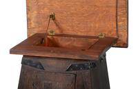 An Arts and Crafts Carved Oak Wine Cellarette
