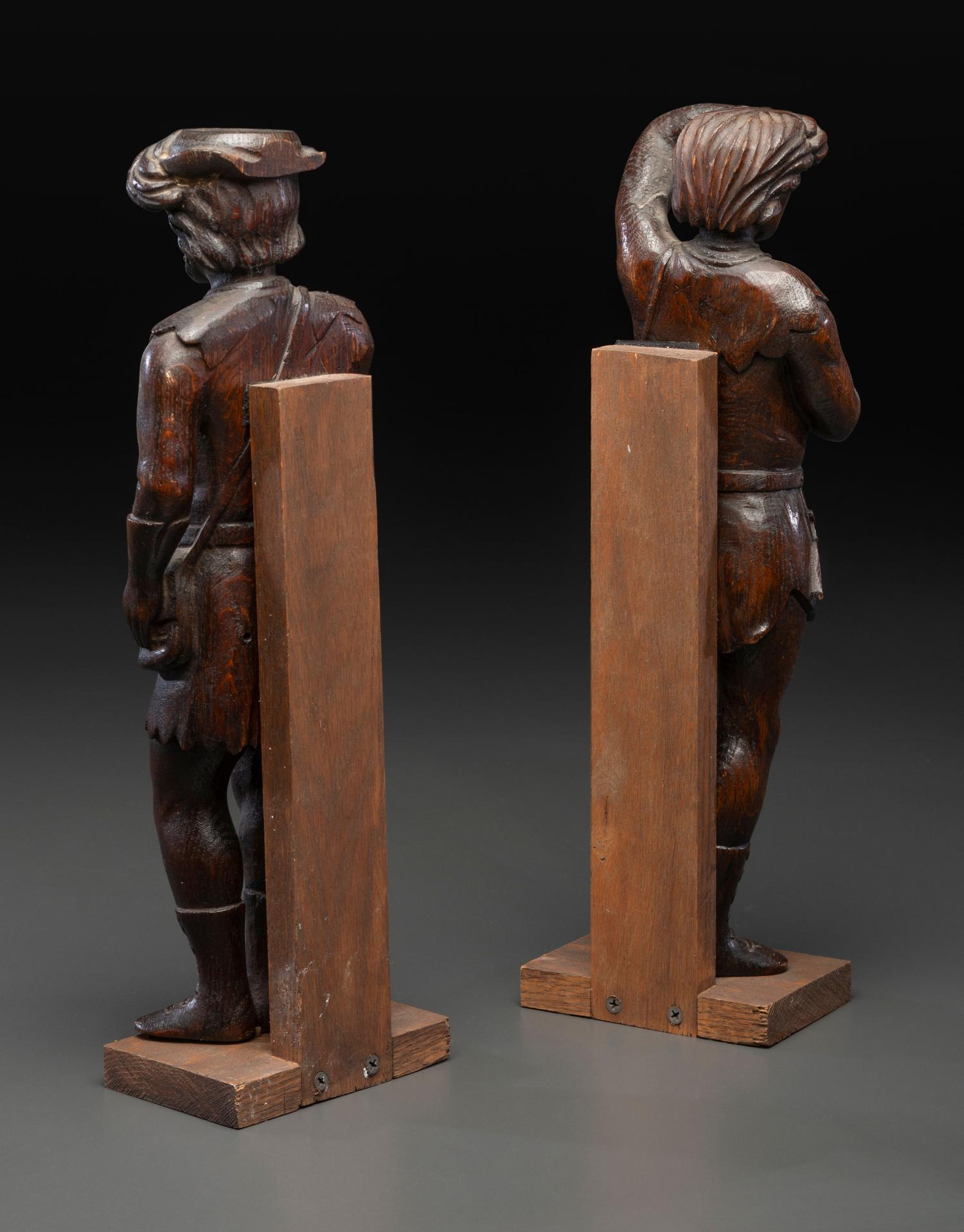 A Pair of Continental Carved Oak Huntsman Figures