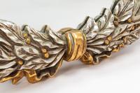 A Pair of Carved, Gilt and Silvered Wood Laurel Wreath Mirrors