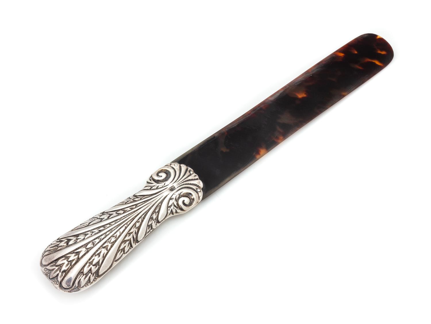 A Victorian Silver Mounted Tortoise Shell Page Turner, Maker's Mark Obscured, London, 1888, the handle worked to show foliate scrolls.