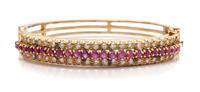A Yellow Gold, Ruby and Diamond Bangle Bracelet, 16.70 dwts.