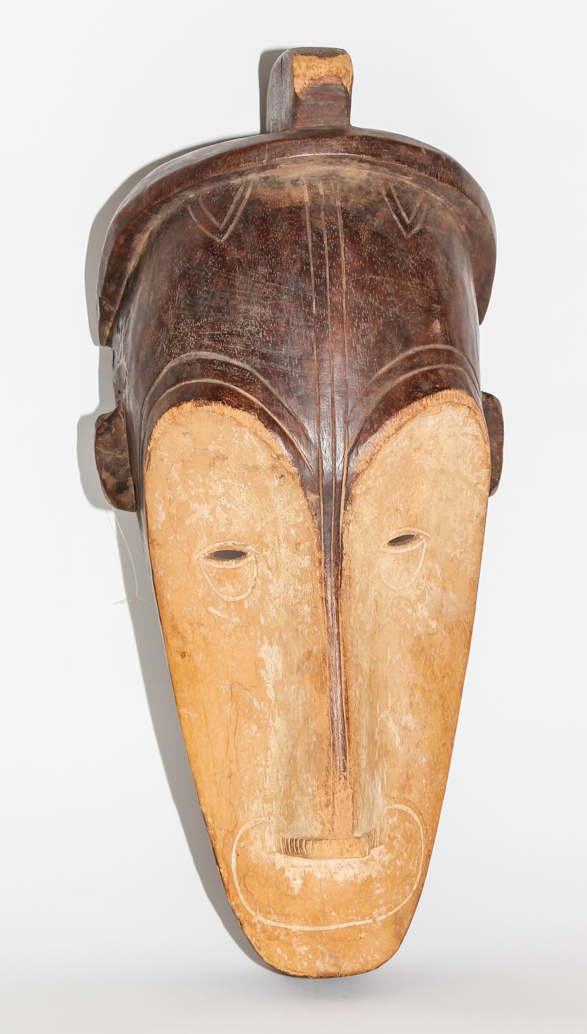 A Gabon Wood Mask, Ngi Society. Height 19 1/4 inches.