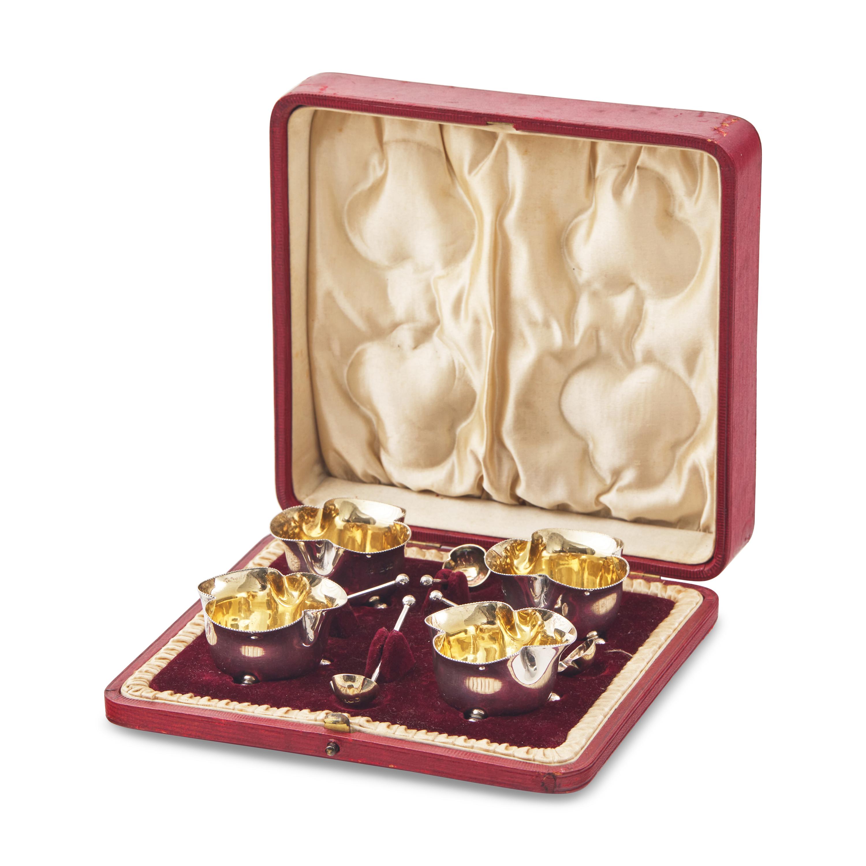 A Set of Four English Silver Trefoil Salt Cellars and a Silver Toast Rack