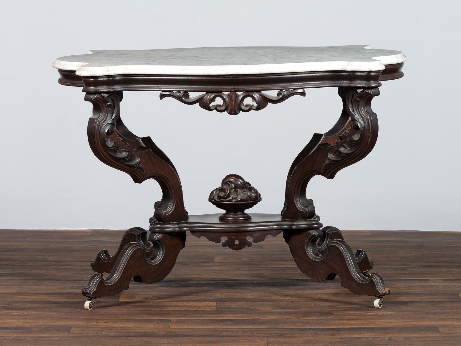 A Renaissance Revival Carved Walnut Marble Top Center Table