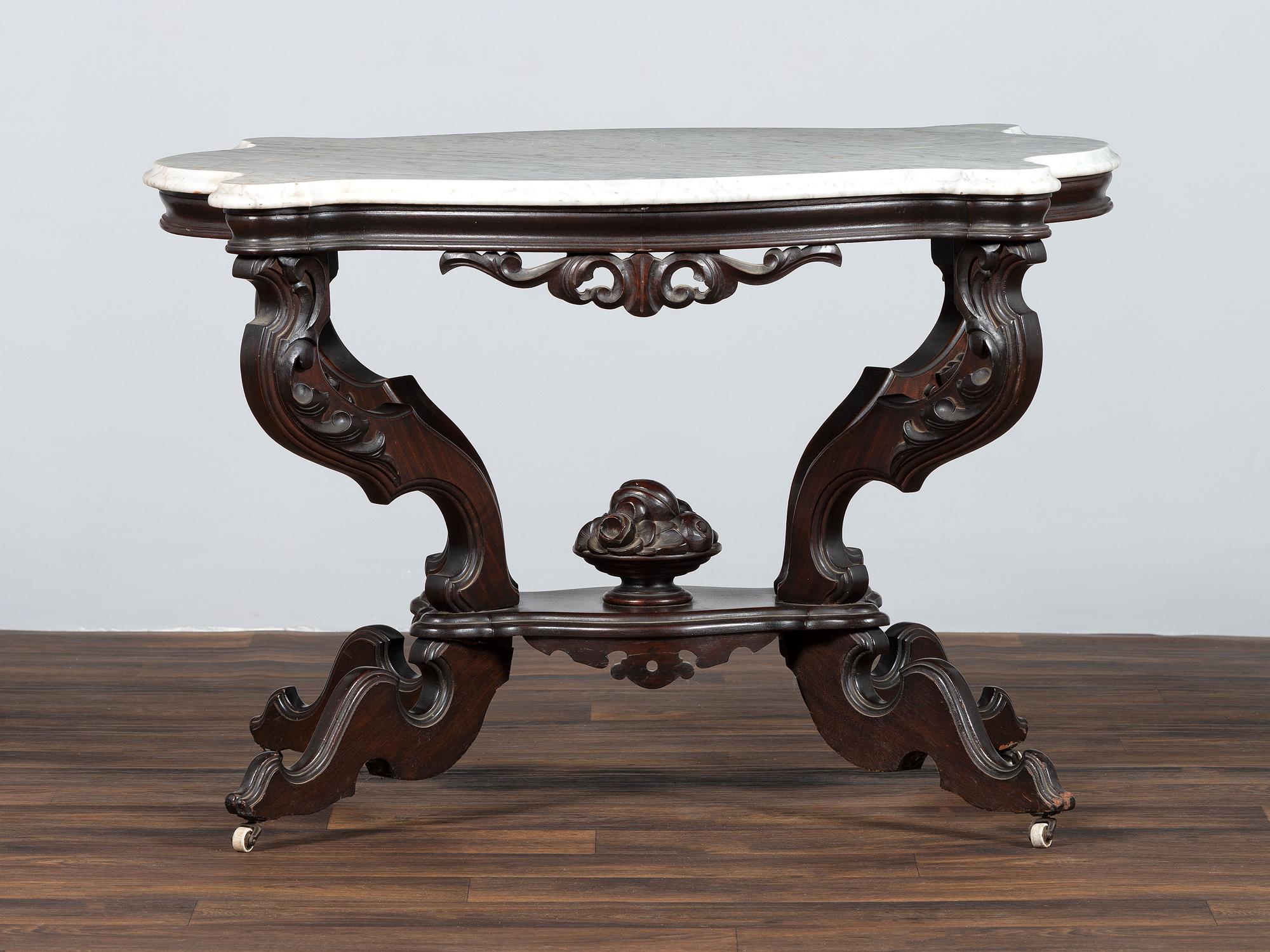 A Renaissance Revival Carved Walnut Marble Top Center Table