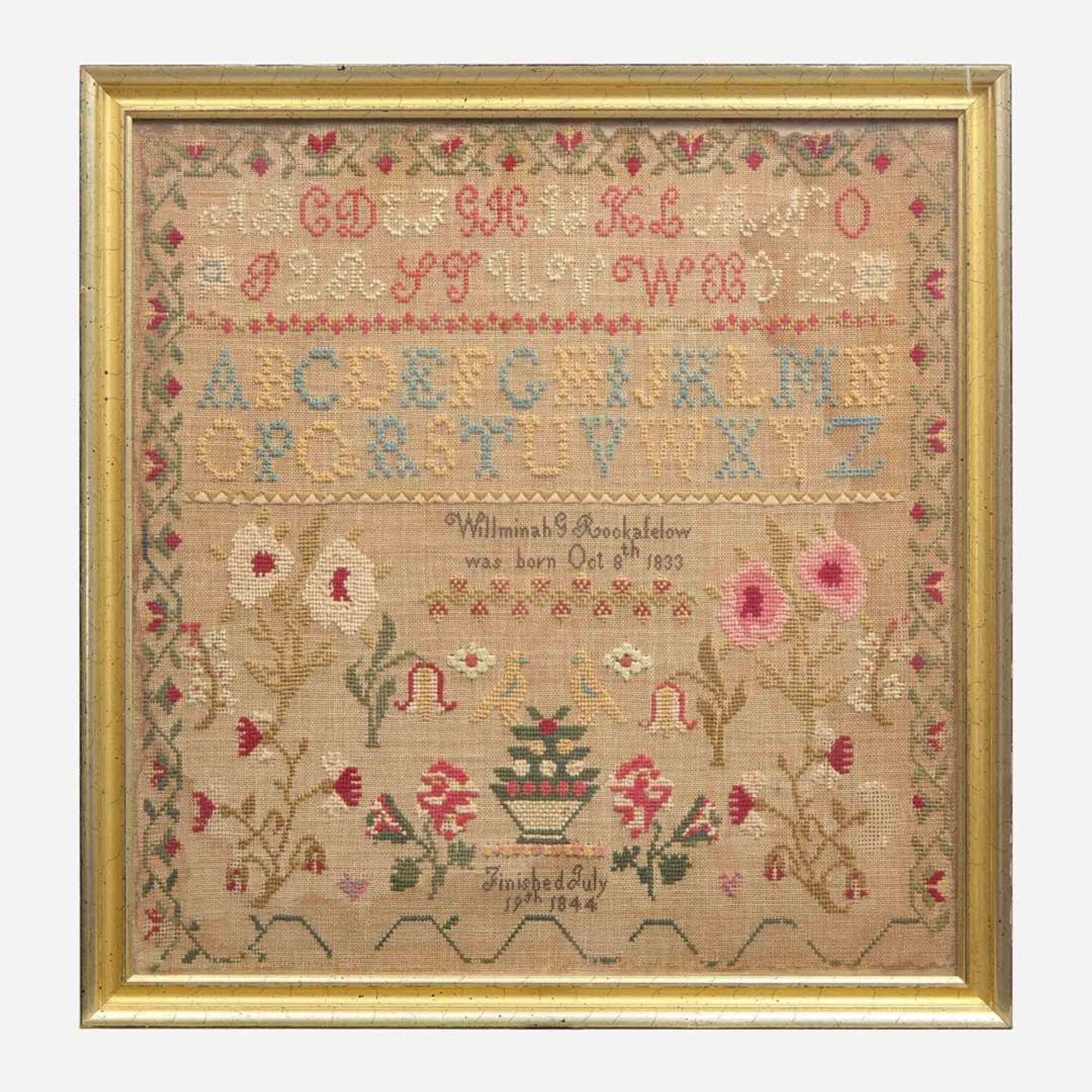 A Federal child's cherry slant-front desk together with a needlework sampler late 18th / early 19th century