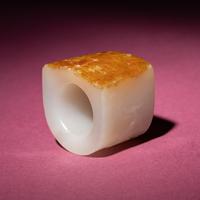 A Chinese Russet and White Jade 'Taotie and Chilong' Archer's Ring, 18th Century — 清中期 白玉留皮饕餮螭龍紋扳指