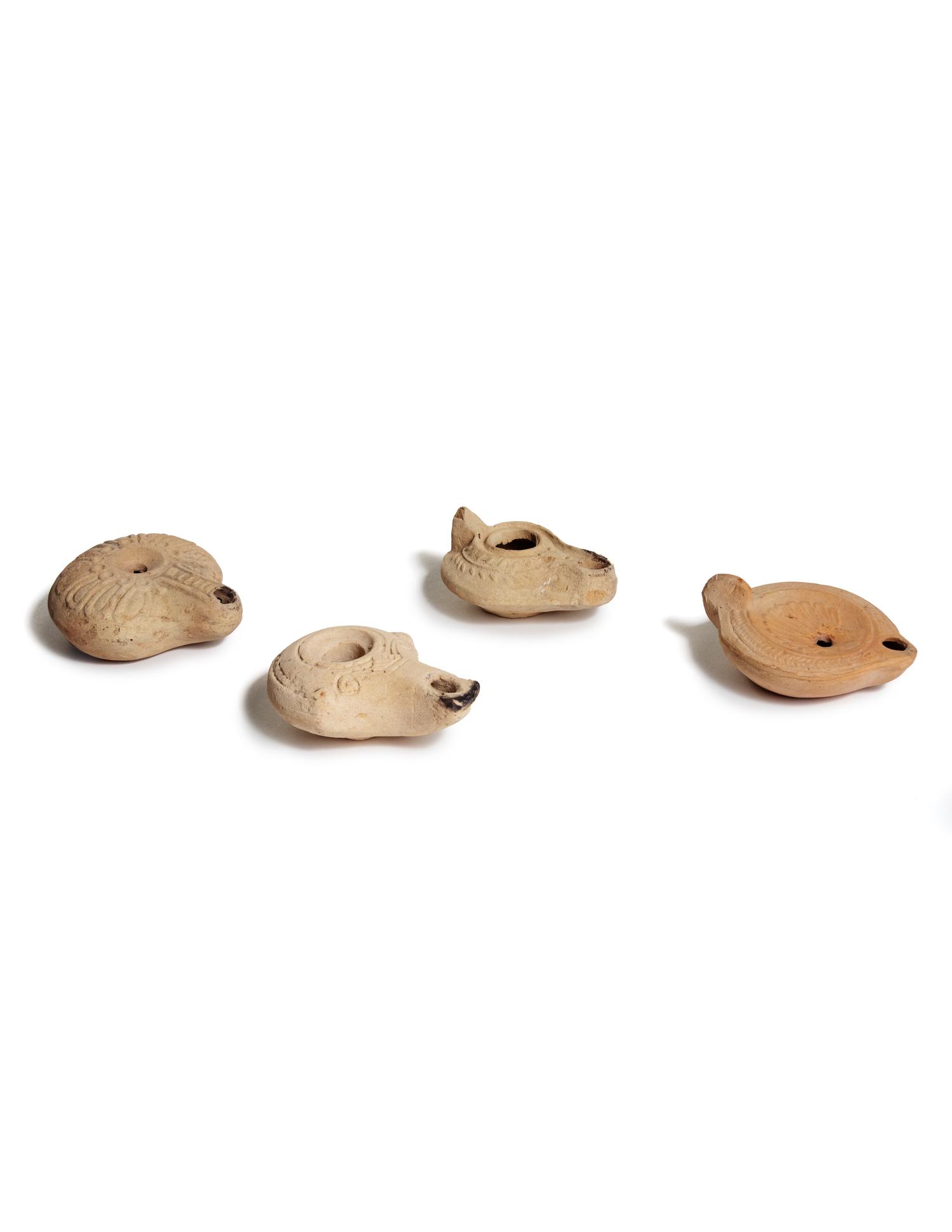 Four Roman Molded Terra Cotta Oil Lamps