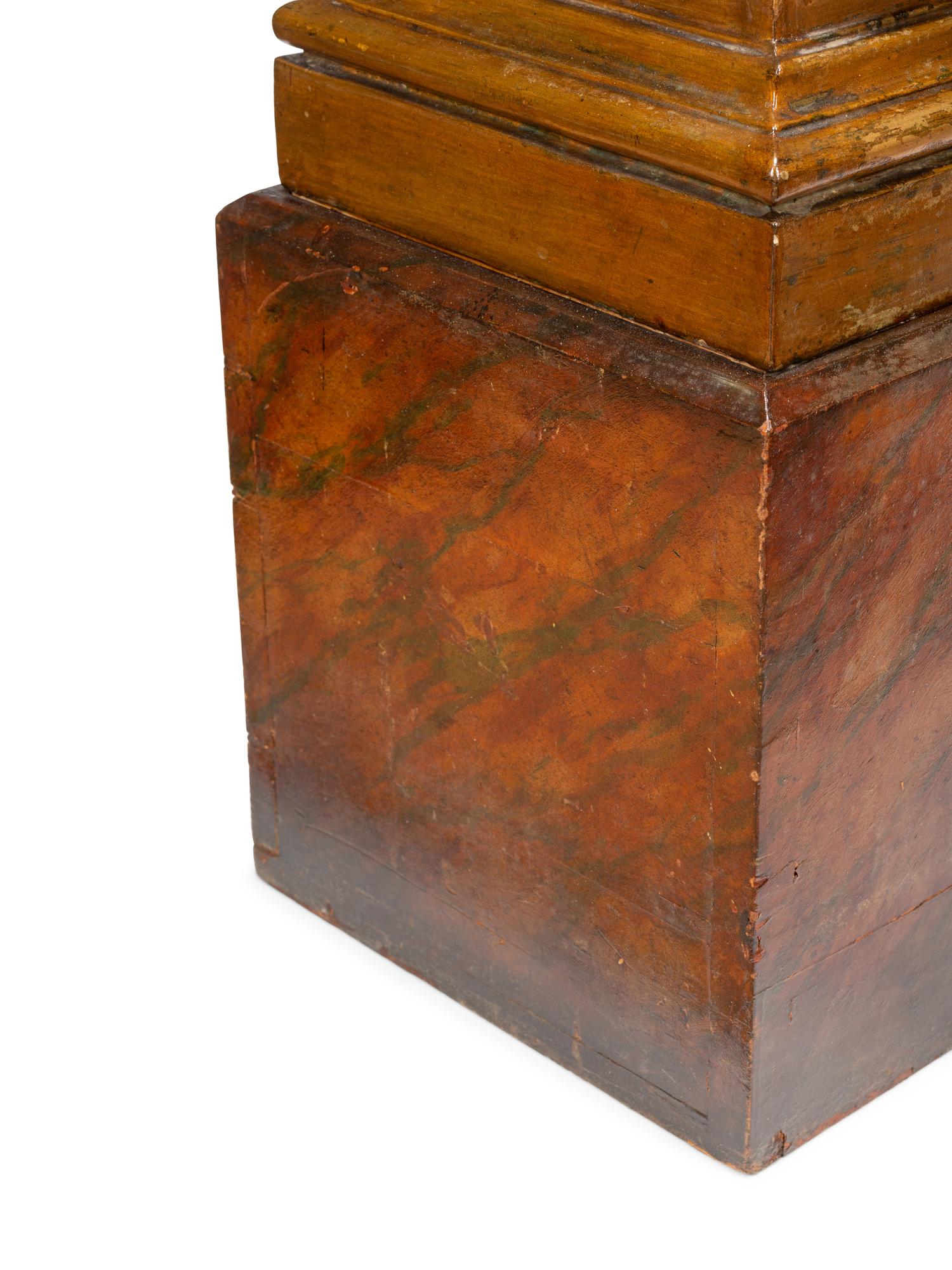 A Pair of Continental Faux Marble Painted and Gilt Pedestals with Putto Masks