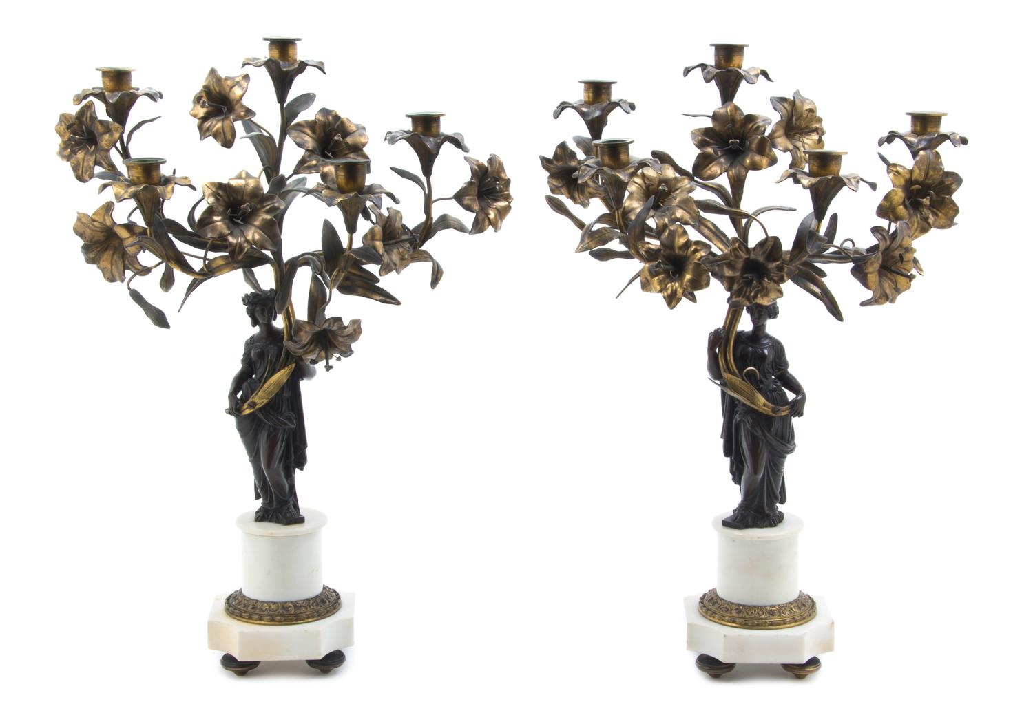A Pair of Patinated and Gilt Bronze Five-Light Figural Candelabra, Height 23 3/4 inches.