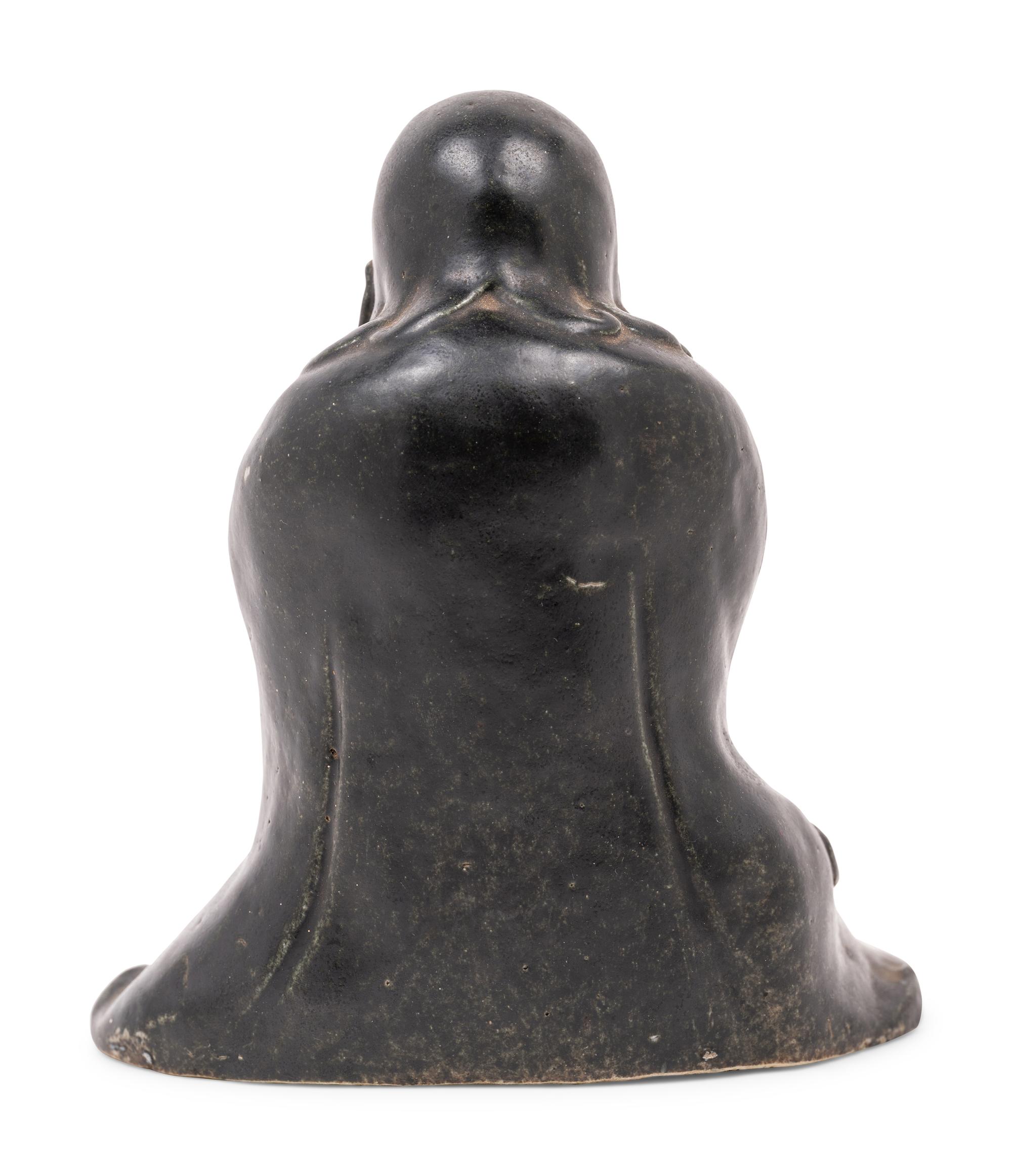 A Chinese Black Glazed Porcelain Figure of Seated Damo