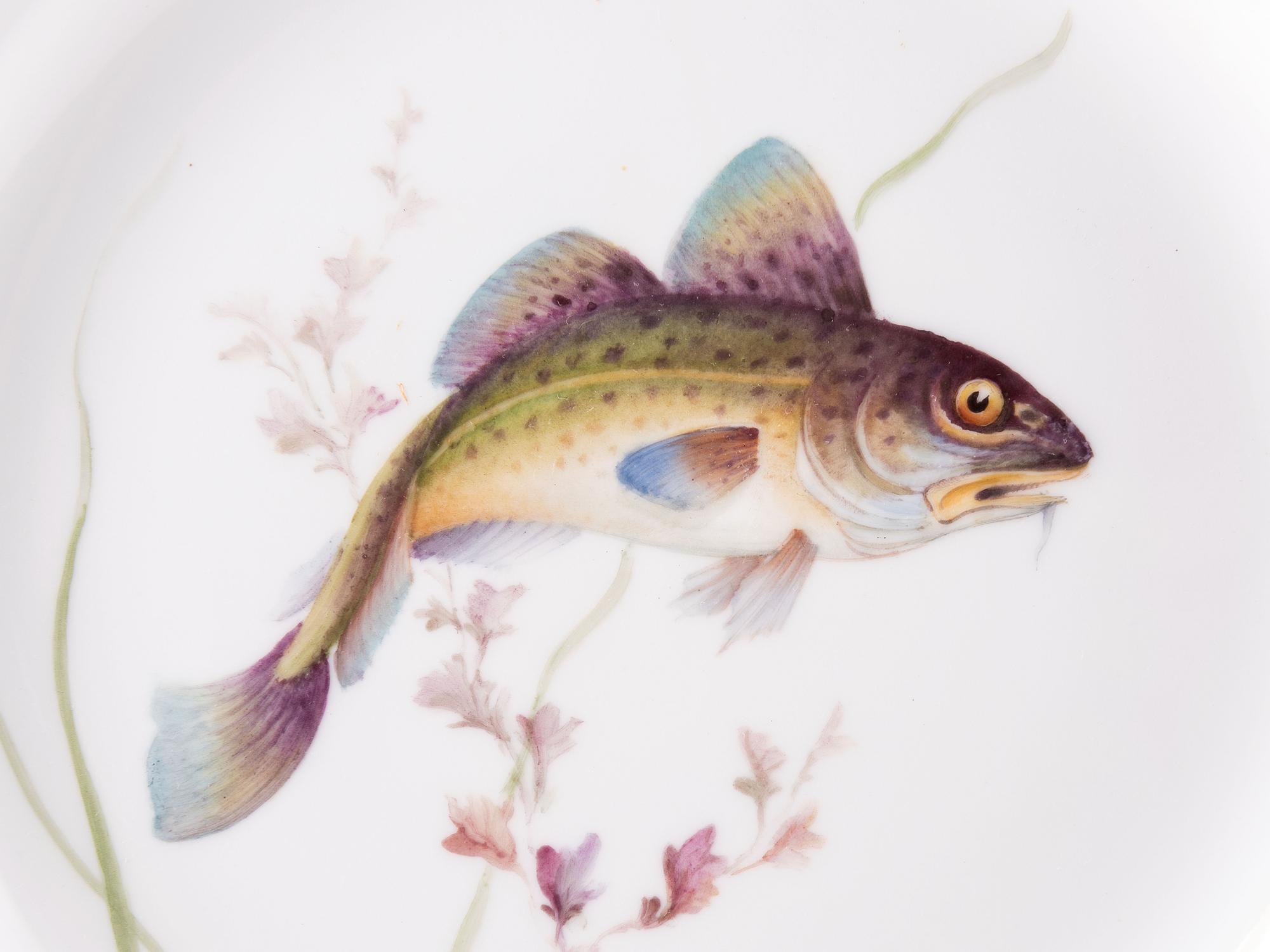 A Set of Twelve Royal Copenhagen Parcel Gilt Porcelain Fish Plates