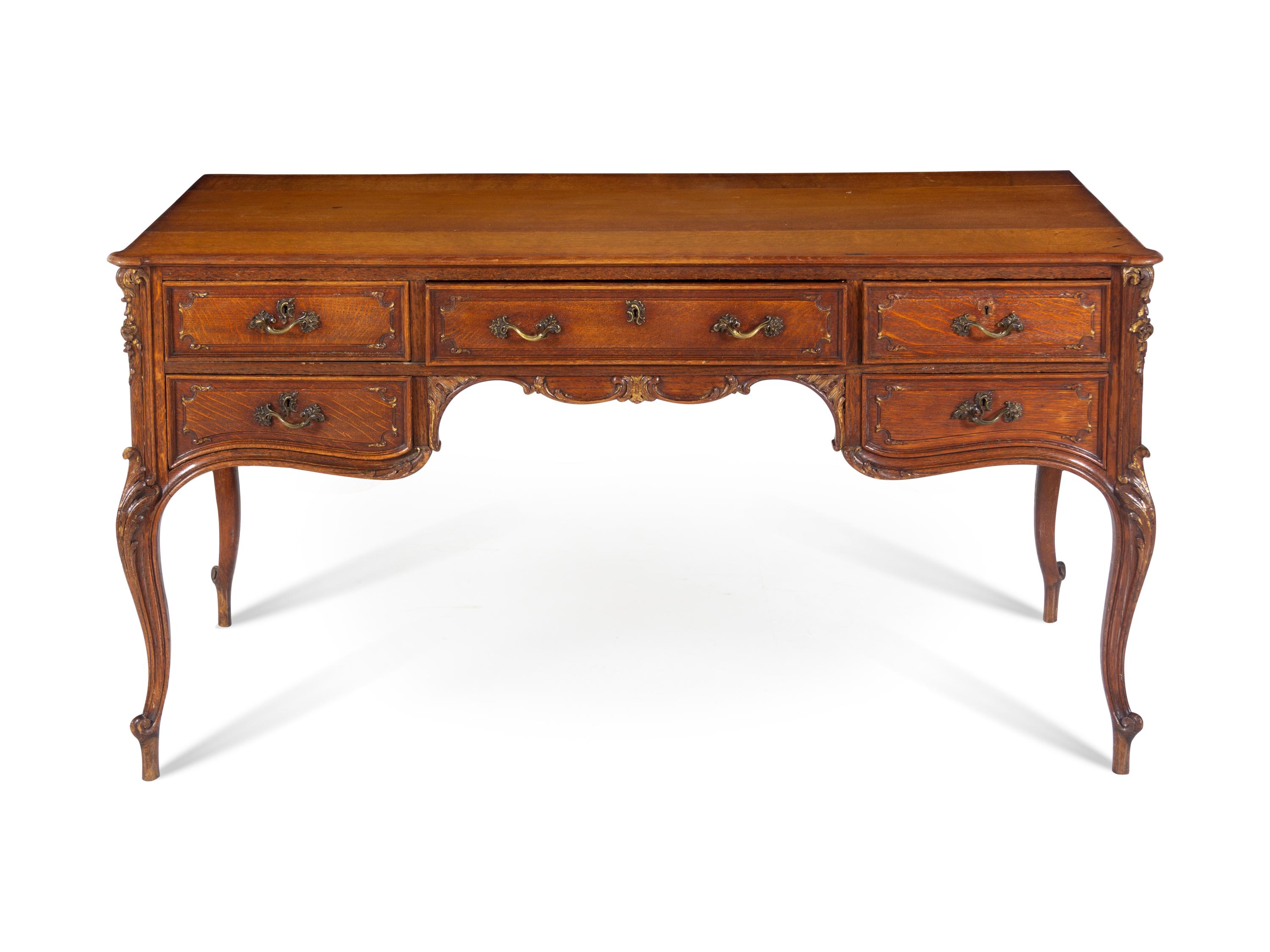 A Louis XV Style Parcel Gilt Oak Bureau Plat