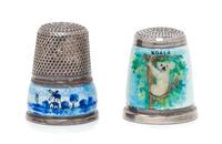 Two German Silver and Enamel Thimbles, , comprising a West German example with a knurled top above a guilloche enamel ground depicting
