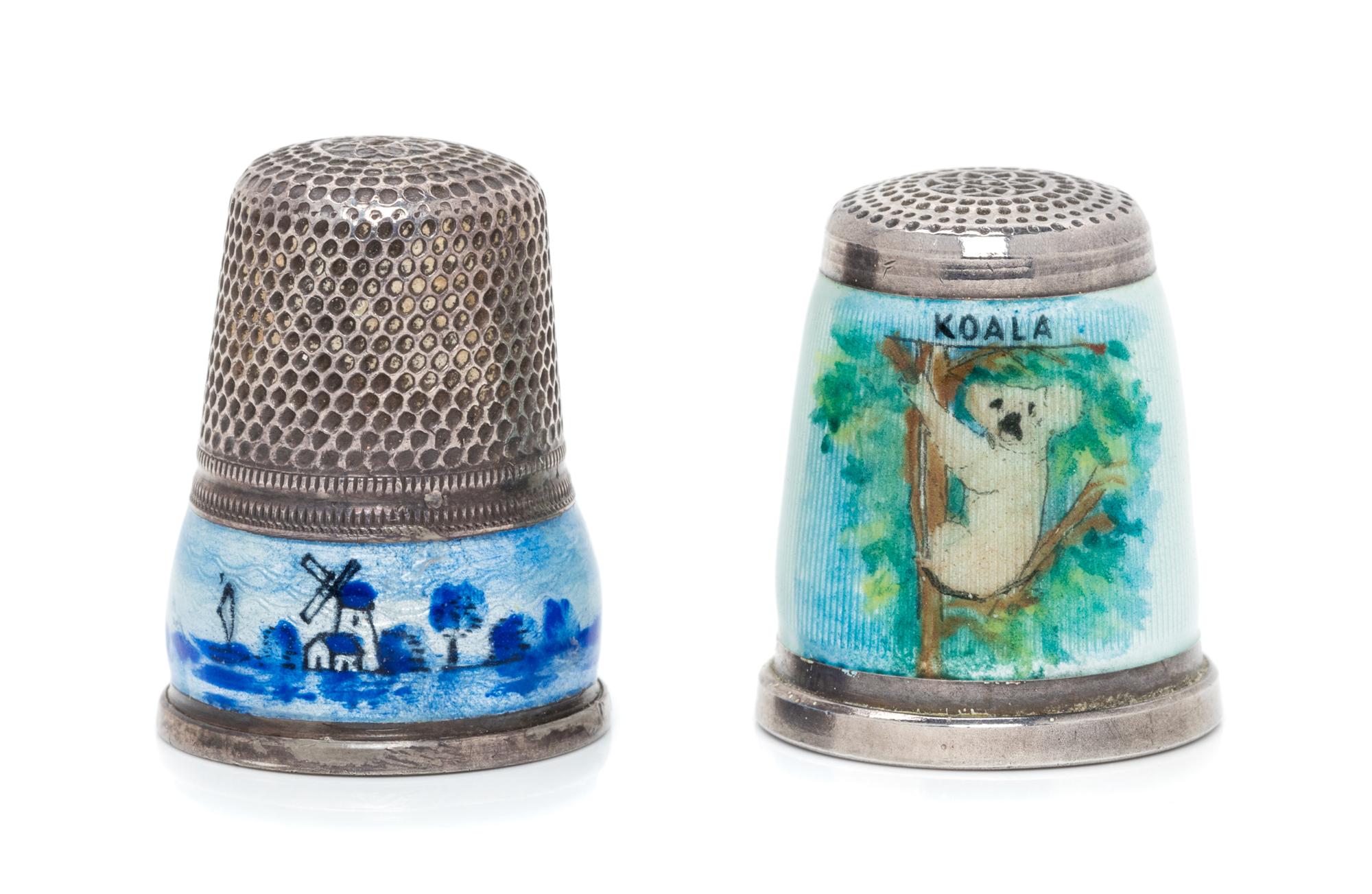 Two German Silver and Enamel Thimbles, , comprising a West German example with a knurled top above a guilloche enamel ground depicting