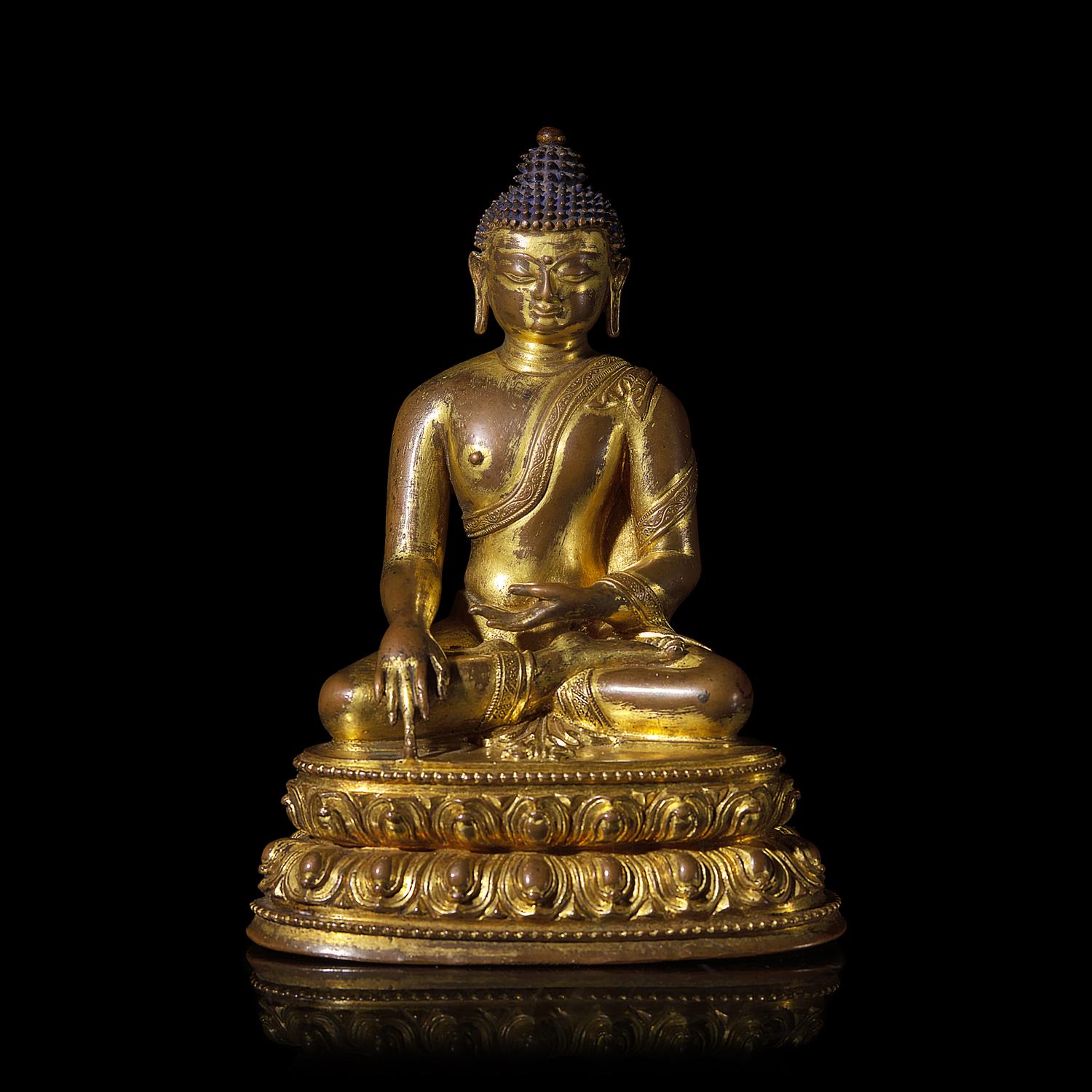 A Tibetan Gilt Copper Alloy Figure of Seated Akshobya, 15th Century 十五世紀 藏傳銅合金阿閦佛