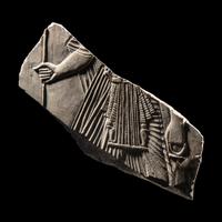 An Egyptian Limestone Relief Fragment with a Pharaoh