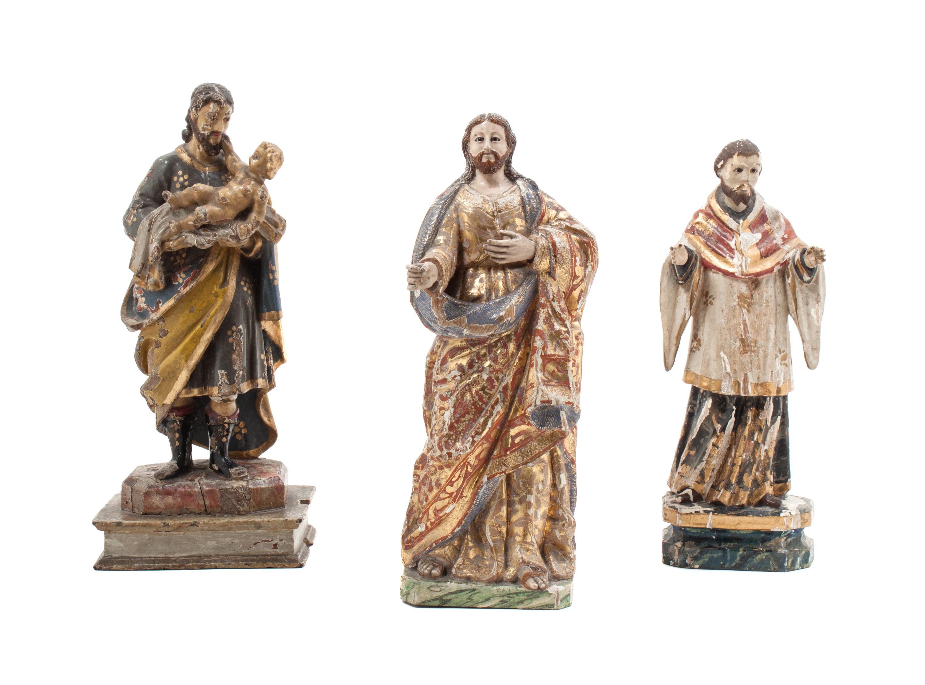Three Carved Wood Santos Figures Height of tallest 12 inches.