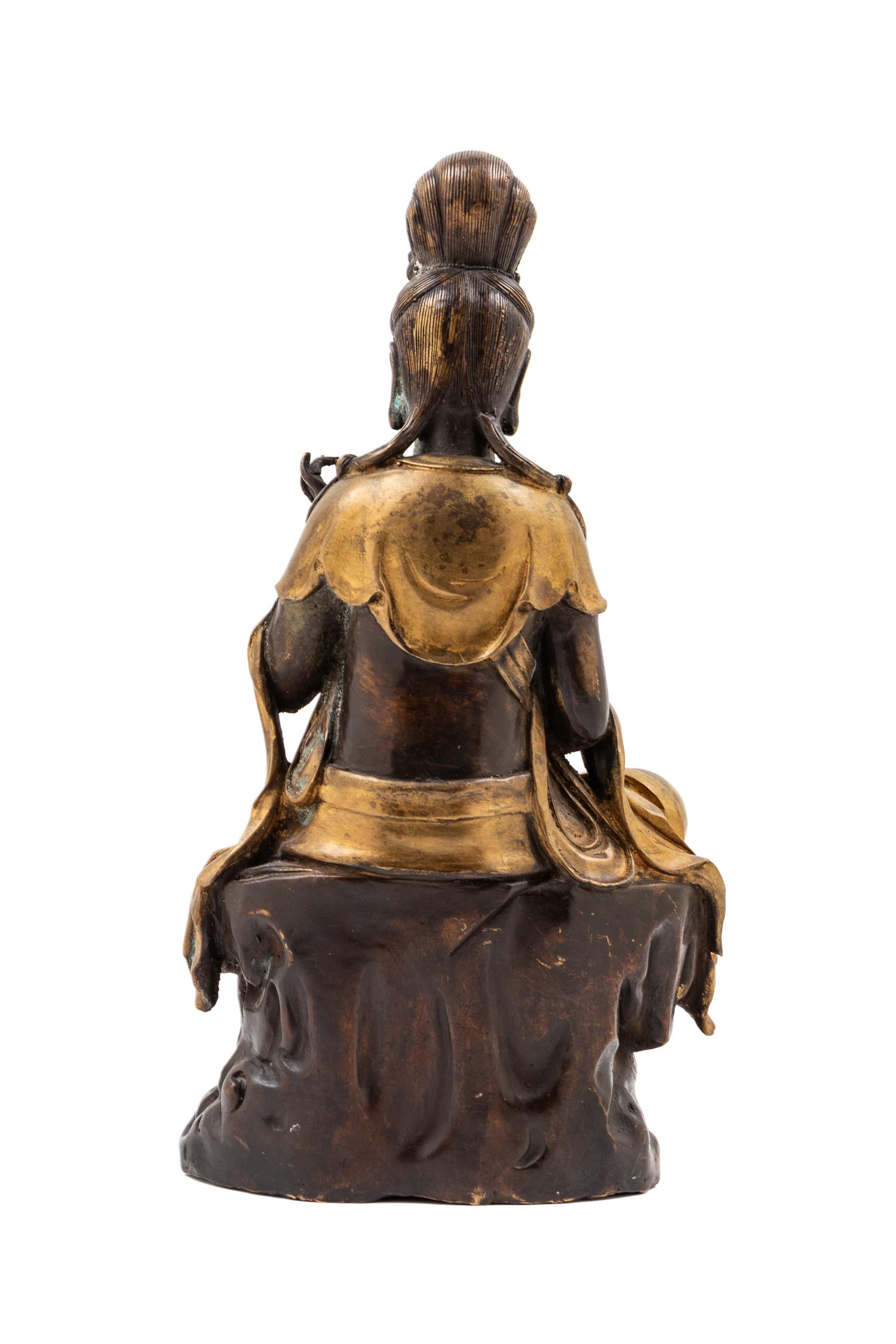 A Chinese Gilt and Patinated Bronze Figure
