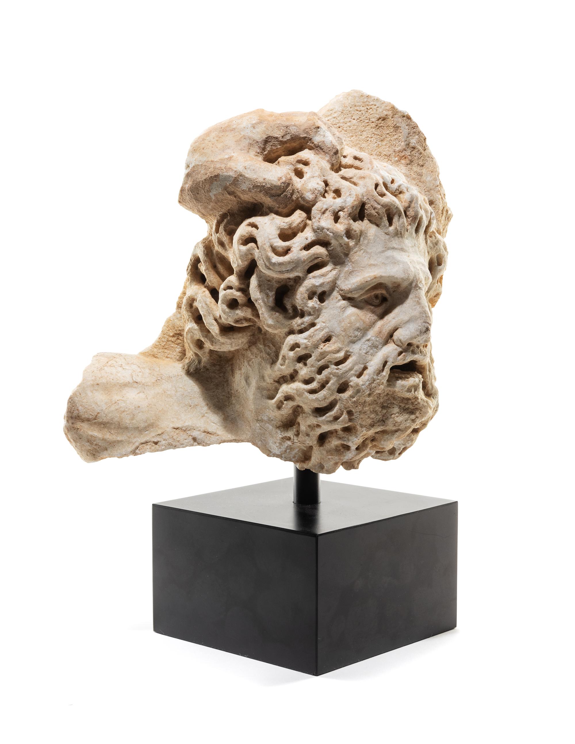 A Roman Marble Bearded Head, Perhaps a Giant, from a Relief