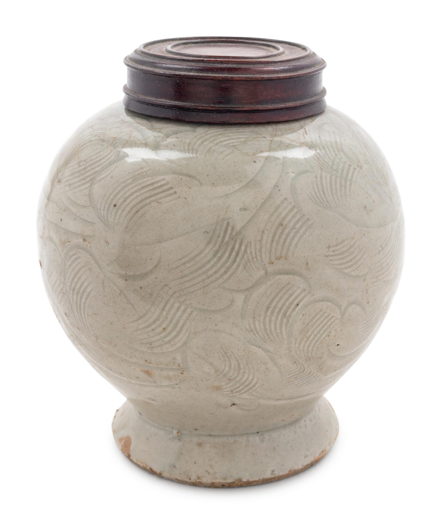 A Celadon Glazed Carved 'Floral' Porcelain Jar